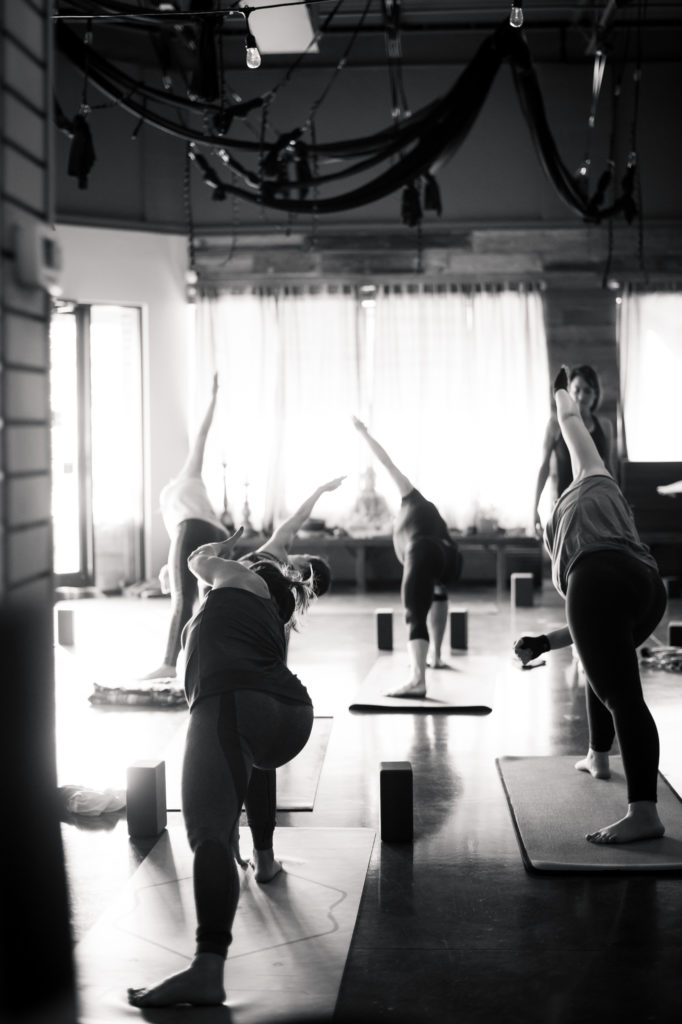 A group led yoga instruction at Yoga Mindset 