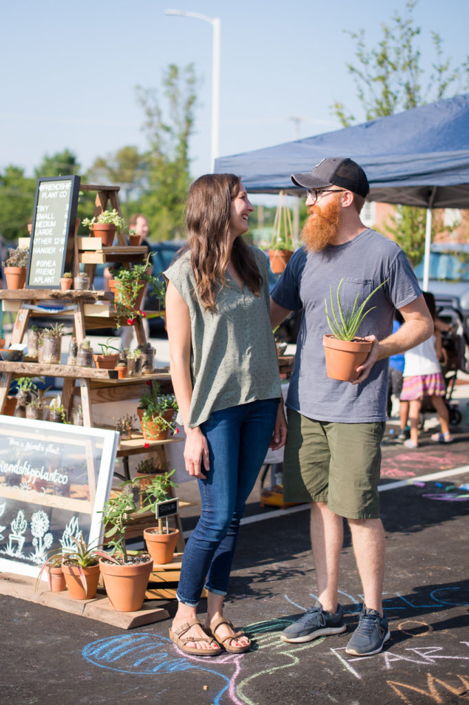 Heather and Evan Blakerby look into each others eyes at the High Point Farmers market 