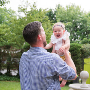 Feature image of Bryan Verstat holds his smiling daughter in High Point, NC