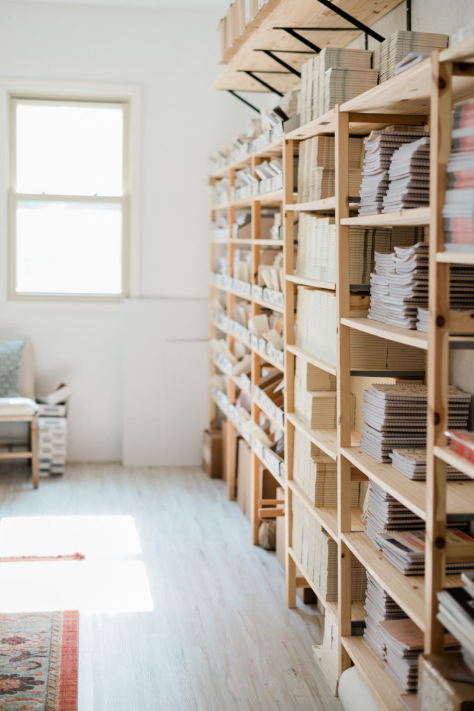Shelves filled to the brim with notebooks, cards, and other stationary from Pen + Pillar. 