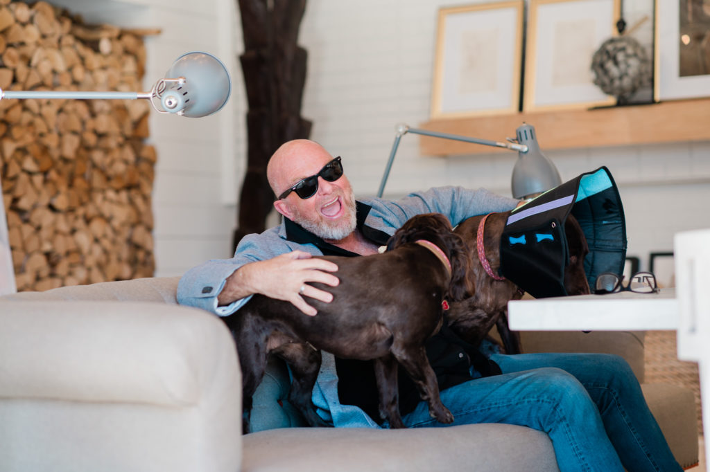 Palmer Smith sits with his dogs on the couch. 