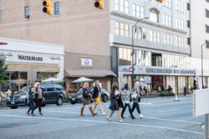 Patrons of the High Point Furniture Market walk across the street to their next destination in downtown High Point 