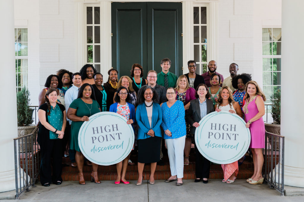 A group of Extraordinary Educators in High Point stand on the front steps of the High Point Country Club.