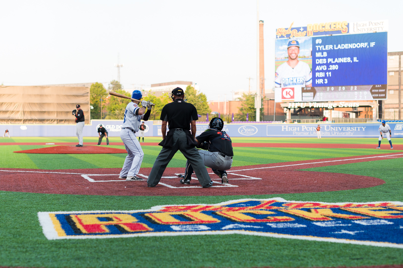 A picture of the High Point Rockers field with several players at home plate.