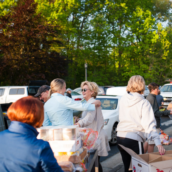 A photo of volunteers at Feeding Lisa's Kids loading cars full of food for the High Point Community