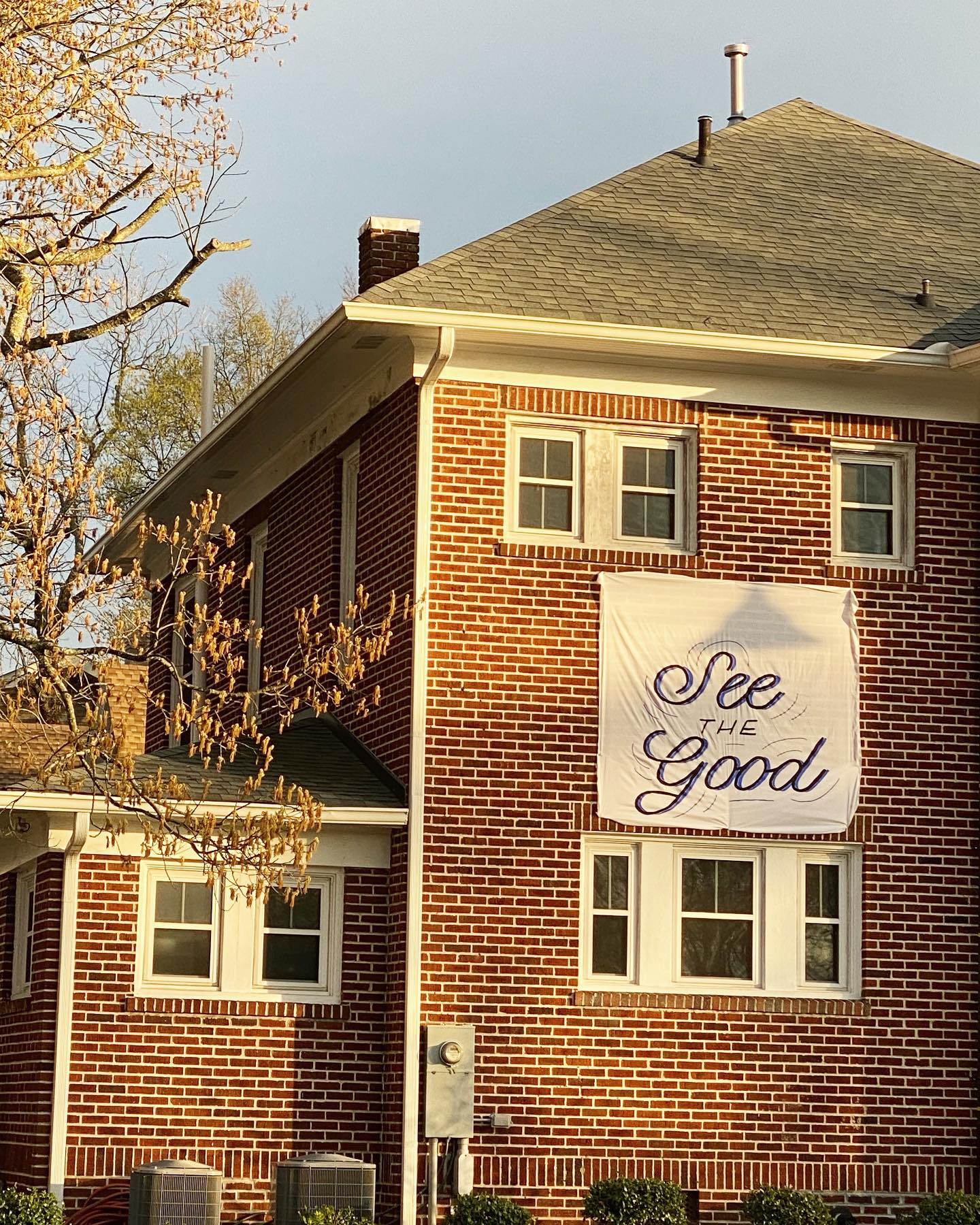 The Barbour Spangle Design building has a sheet on it that says "See The Good."
