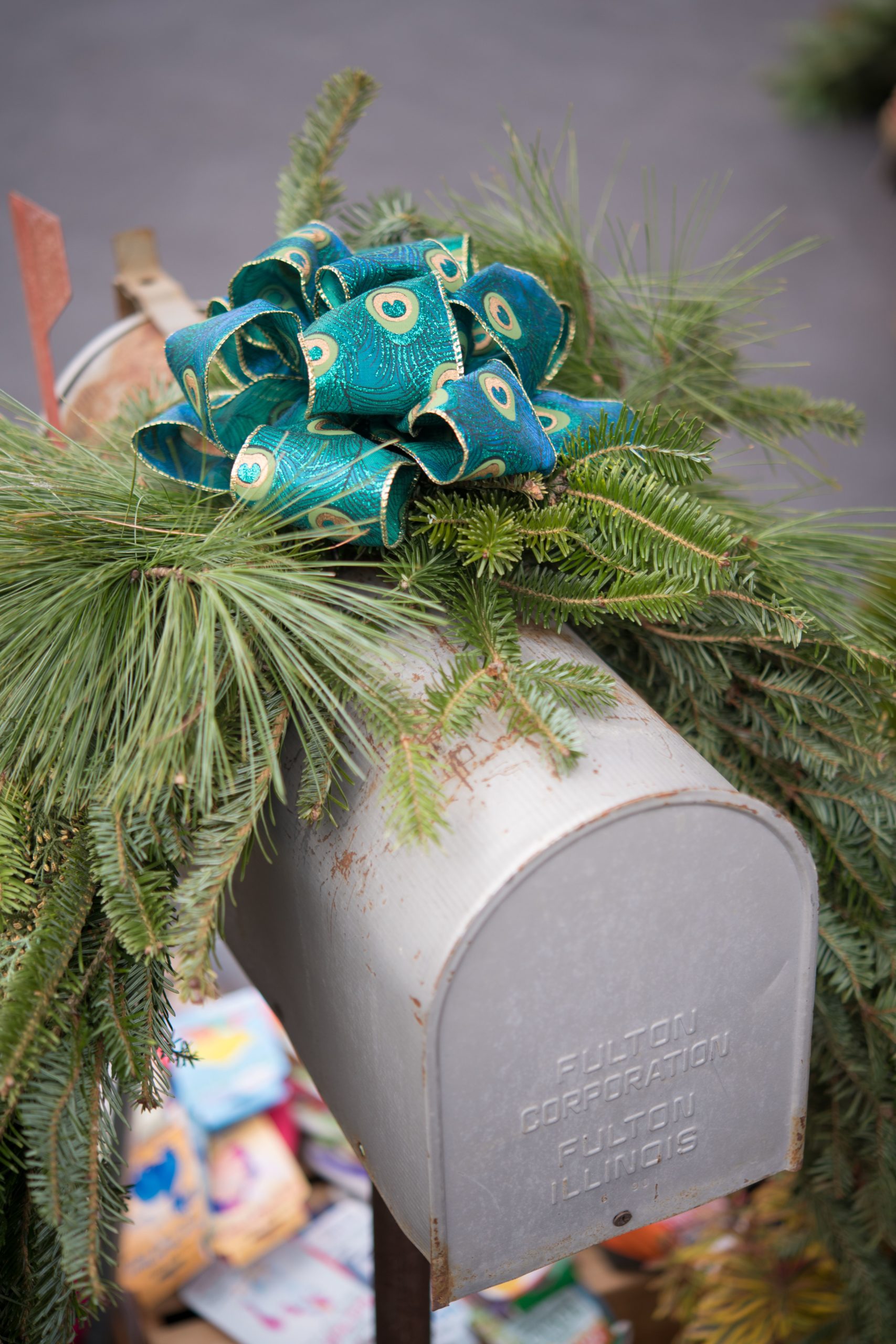 Mailbox with a blue bow and greenery.