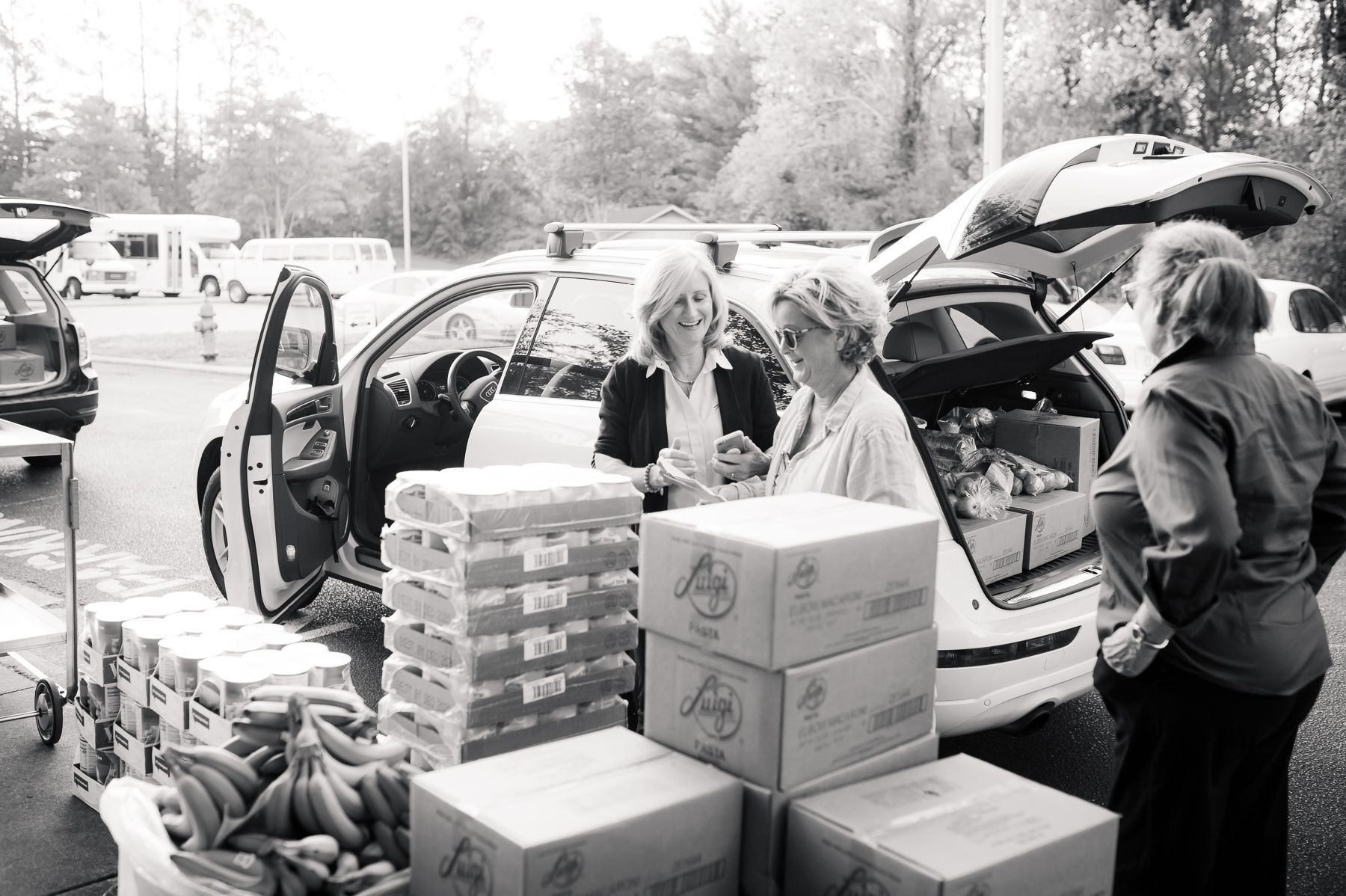 Lisa Hawley of Feeding Lisa's Kids loads food in crates into a car.