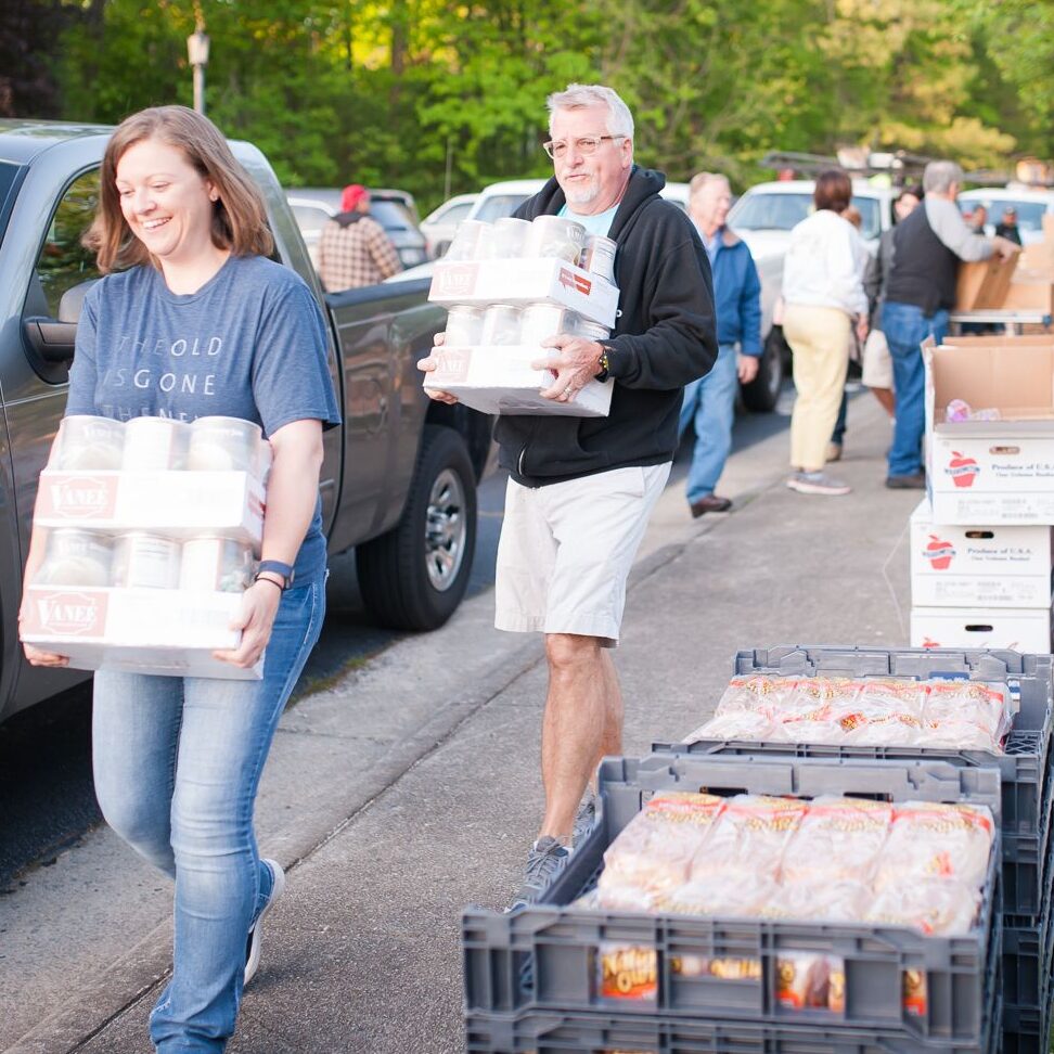 Volunteers loading cars of canned goods in High Point, NC