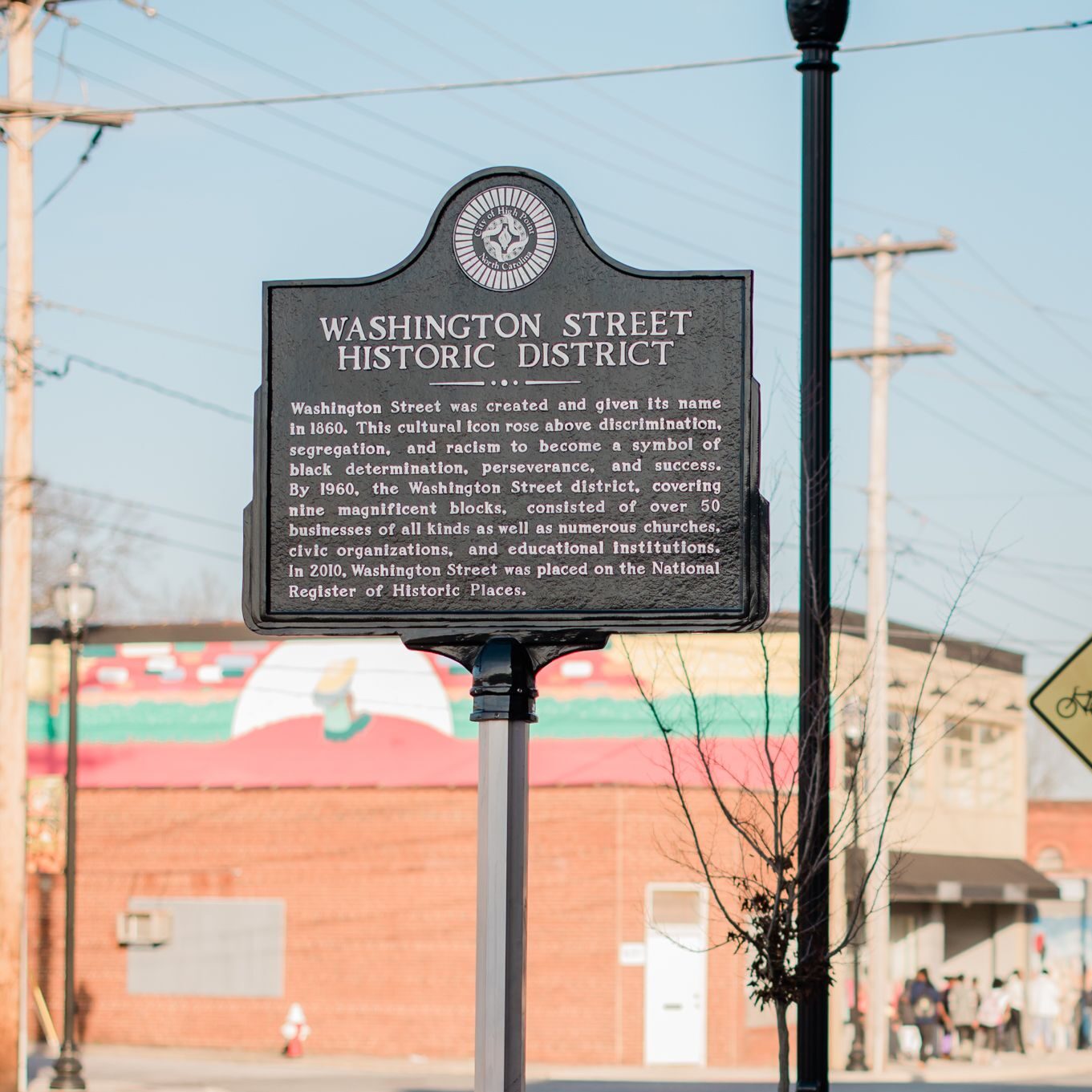 A historic sign marker stands on Washington Street in High Point, NC.