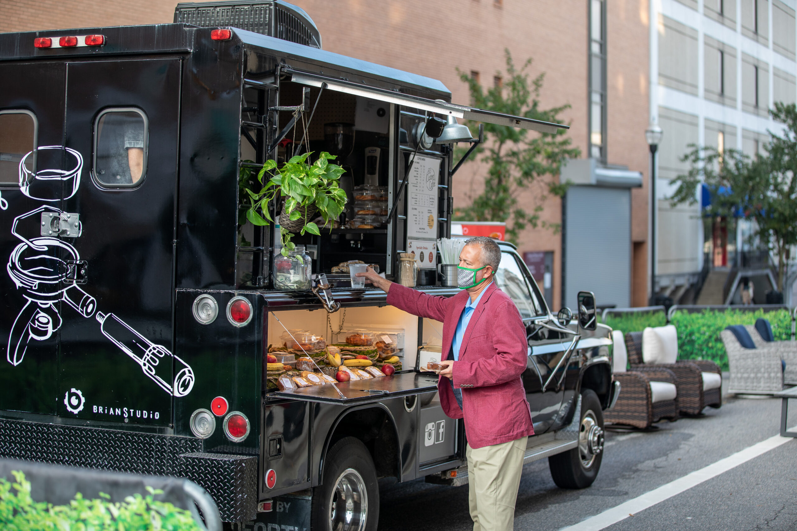 A man orders a coffee from 83 Custom Coffee truck at High Point Market in High Point, NC.
