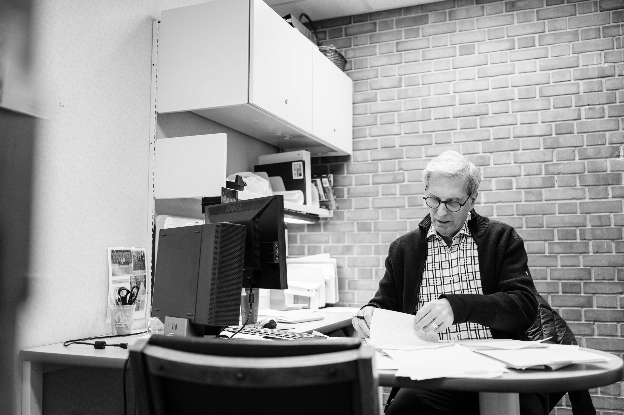 Dr. Frosty Culp sits at a desk in the Community Clinic of High Point working on paperwork. 