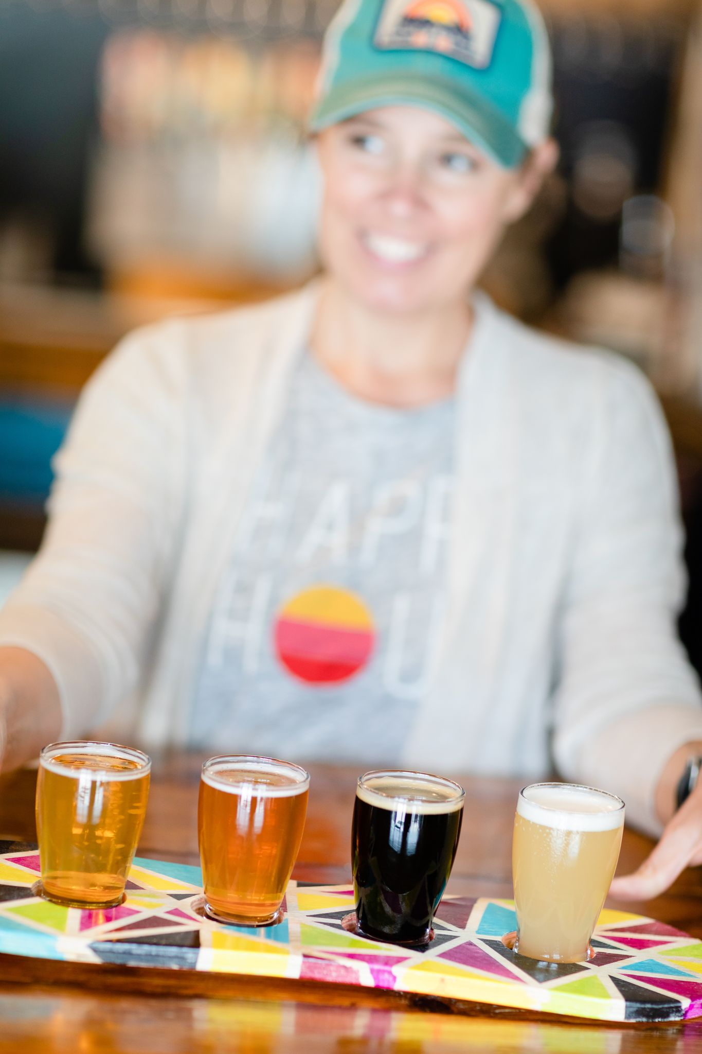 Tiffany Thompson holds out a flight of beers from Goofy Foot Taproom in High Point, NC.