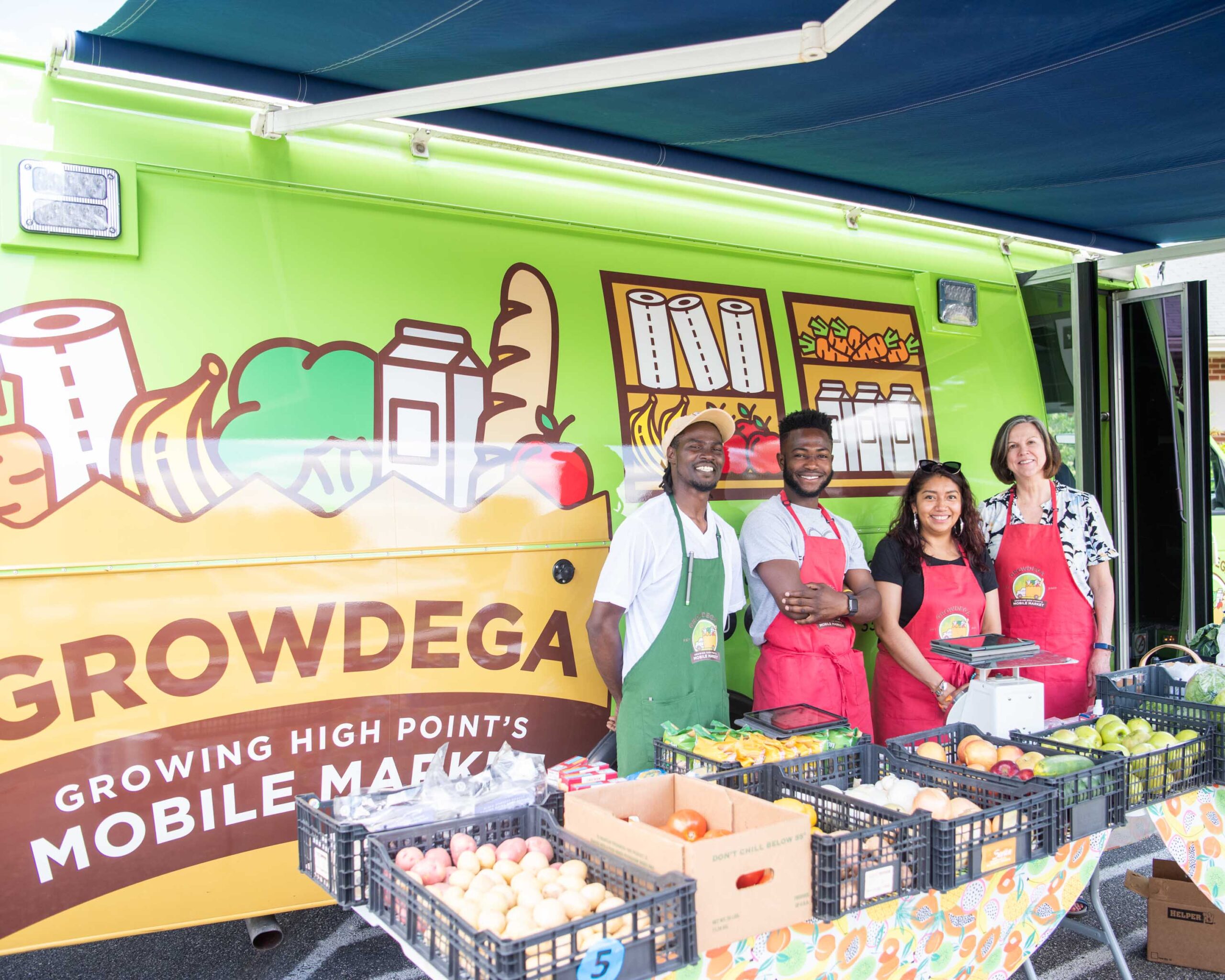 Employees of Growing High Point stand in front of Growdega, a mobile grocery store in High Point, NC.