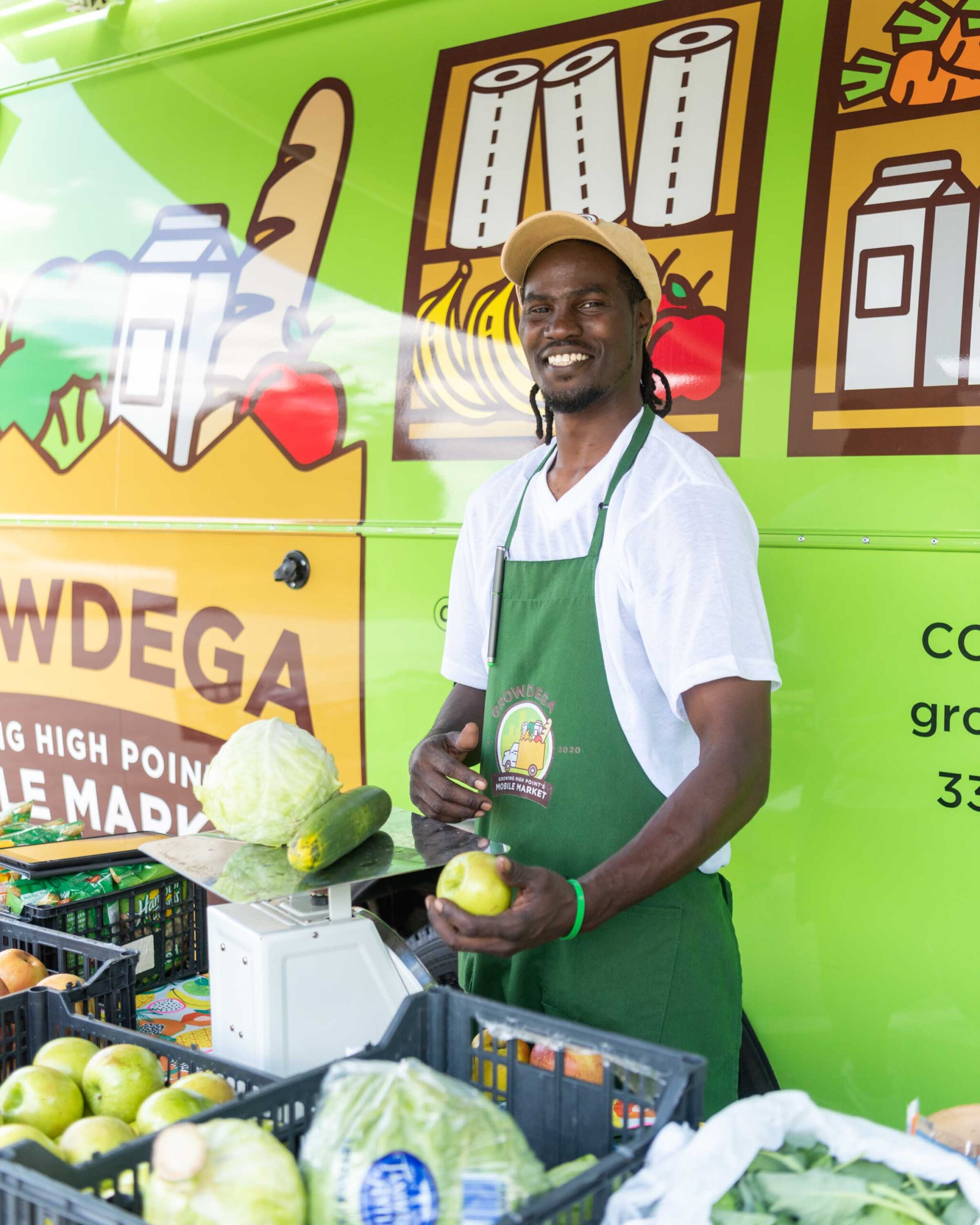 Donnie Matthews, an employee of Growdega stands with produce.