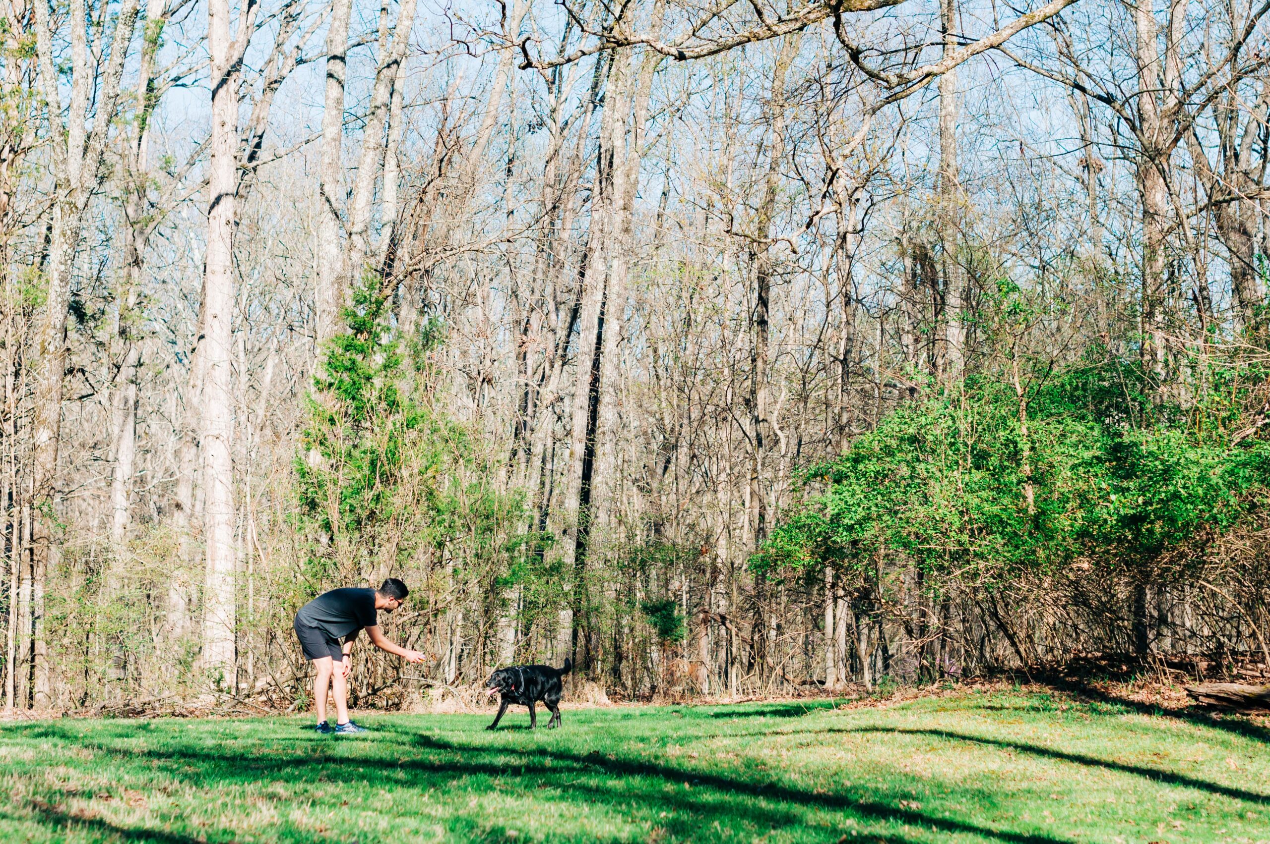A man stands with his dog at the Piedmont Environmental Center in High Point, NC. 