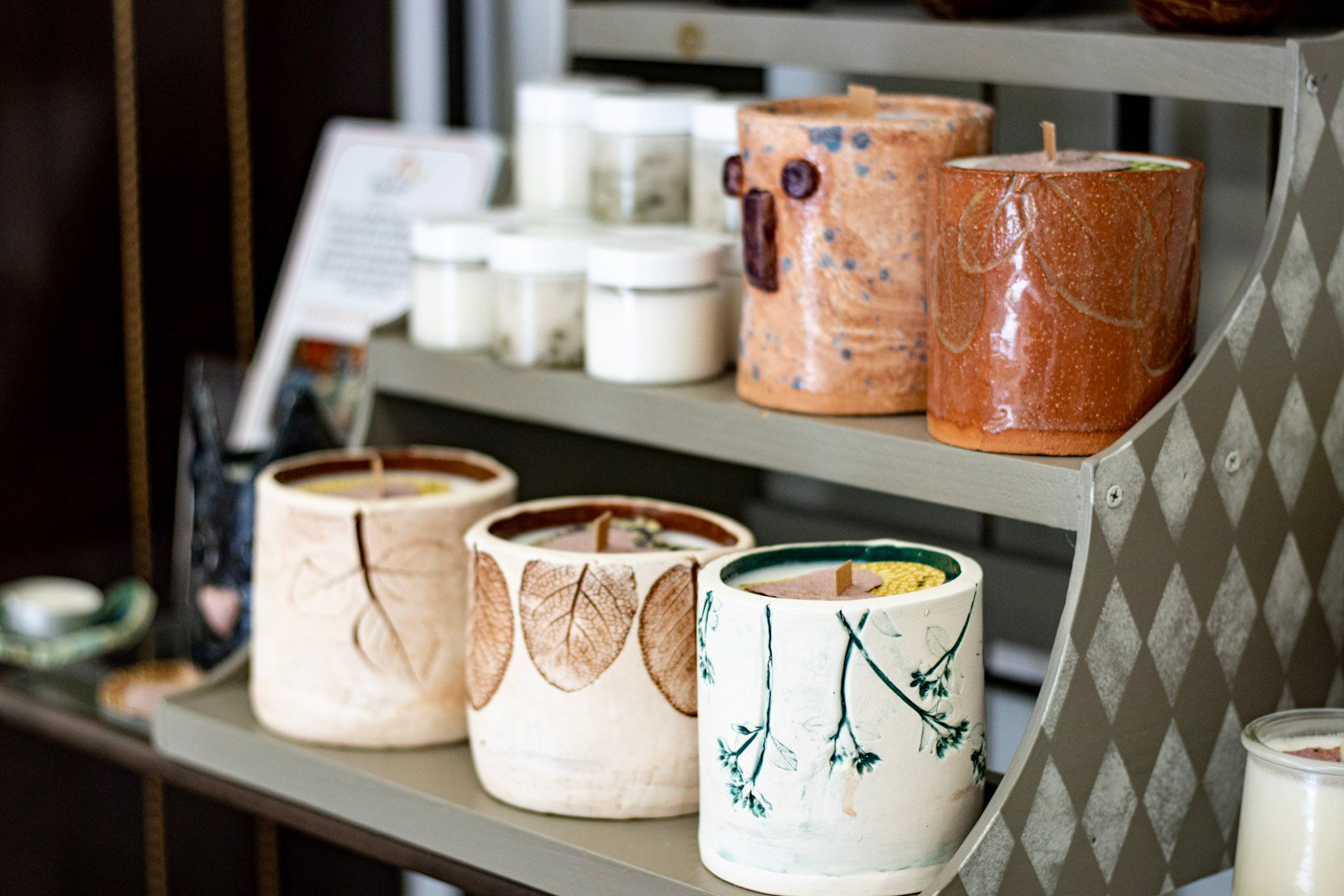 Hand-painted candles sit on a shelf at Wild and Free in High Point, NC.