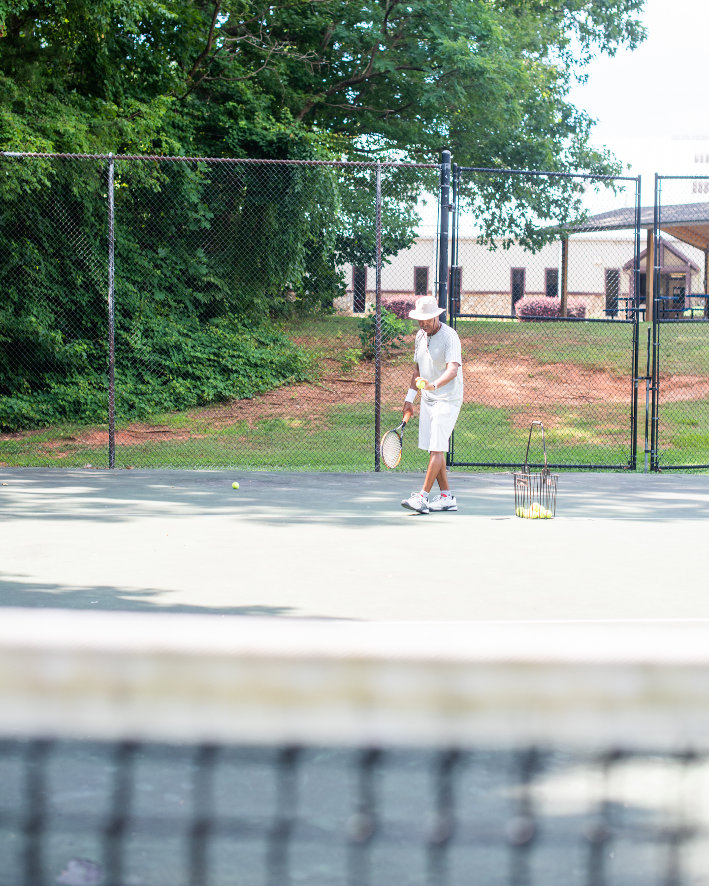 Tennis director prepares to serve a ball at the Oak Hollow Tennis Center in High Point, NC.