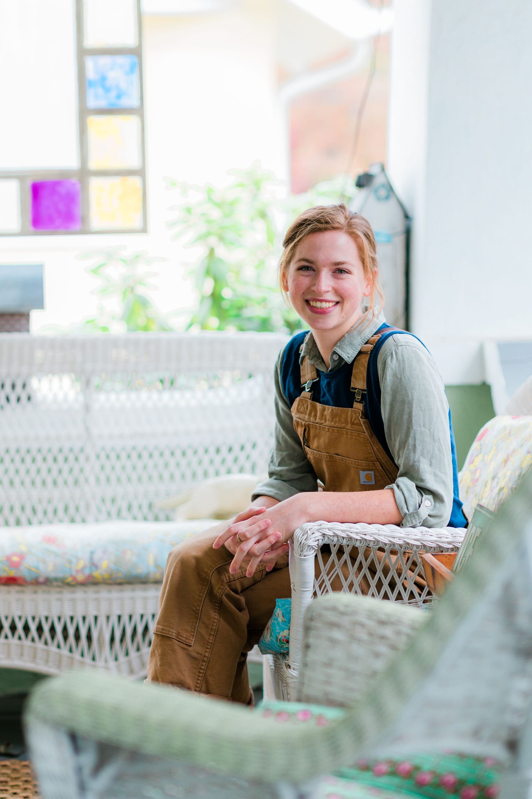 Annabella Boatwright, owner of Neon Tumbleweed Studio in High Point, sits on her studio porch.