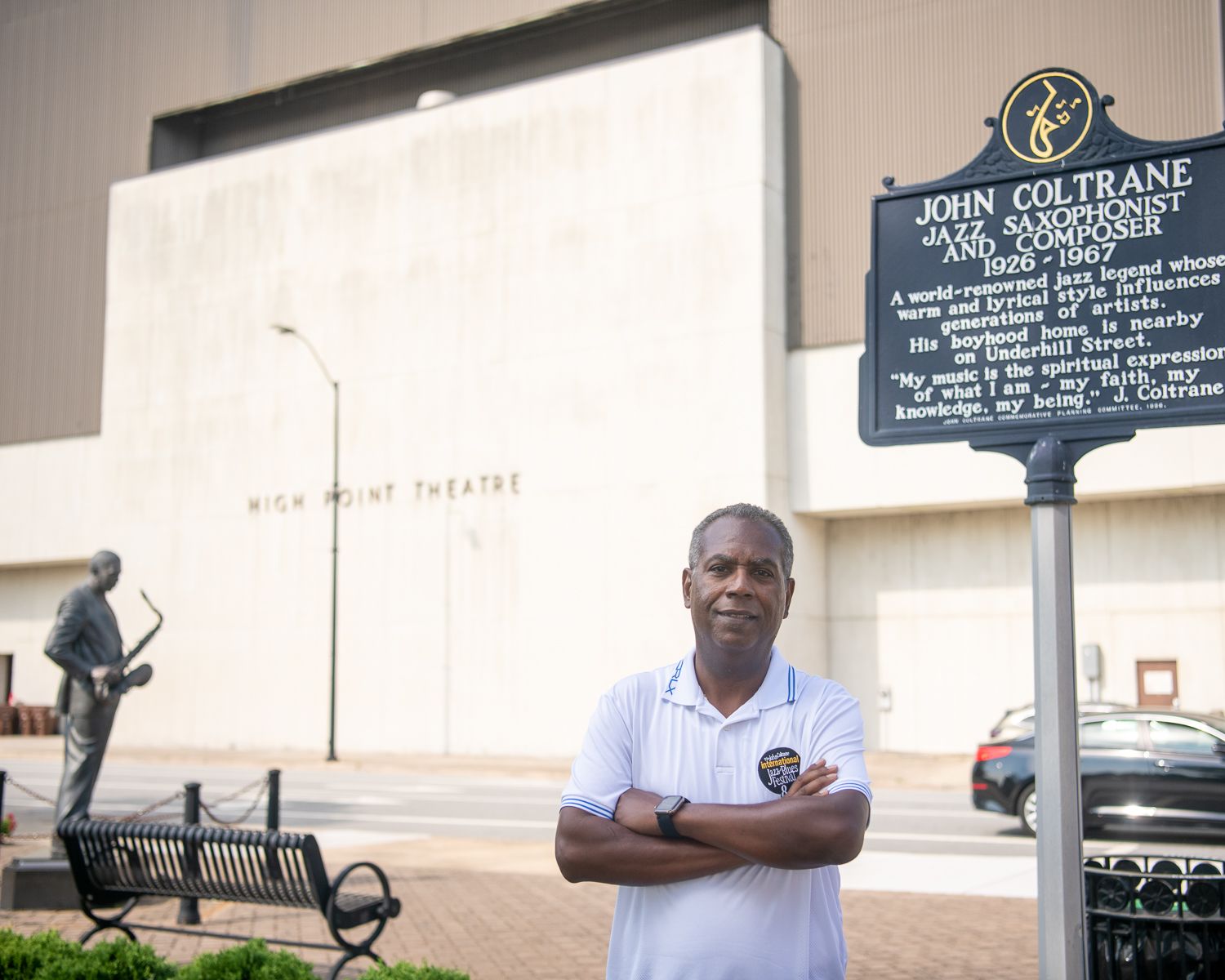 Joe Williams stands in front of John Coltrane's statue in High Point, NC.