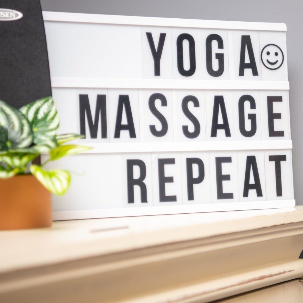 A sign that says "Yoga, Massage, Repeat" at Willow Wellness Center in High Point, NC.