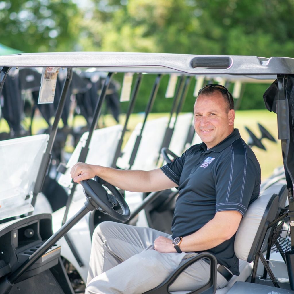 Lee Tillery, Director of High Point Parks & Recreation, sits on a golf cart at Oak Hollow Golf Course.