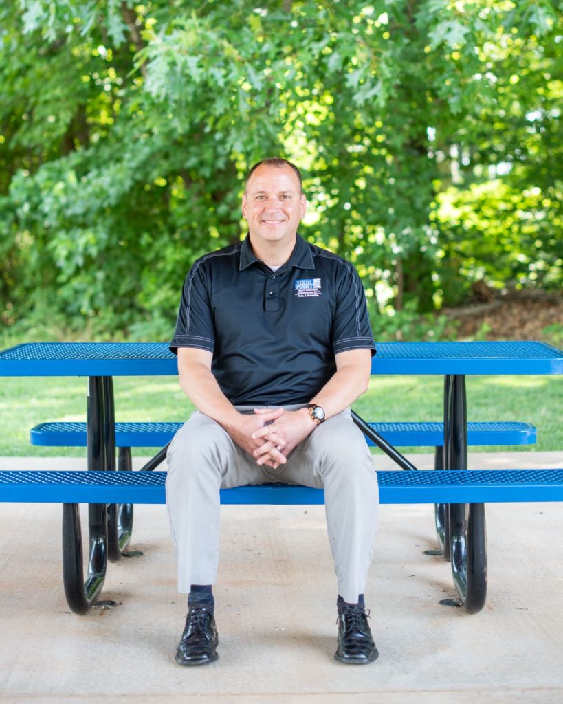 Lee Tillery, Director of High Point Parks & Rec, sits at a picnic table at the High Point Tennis Center.