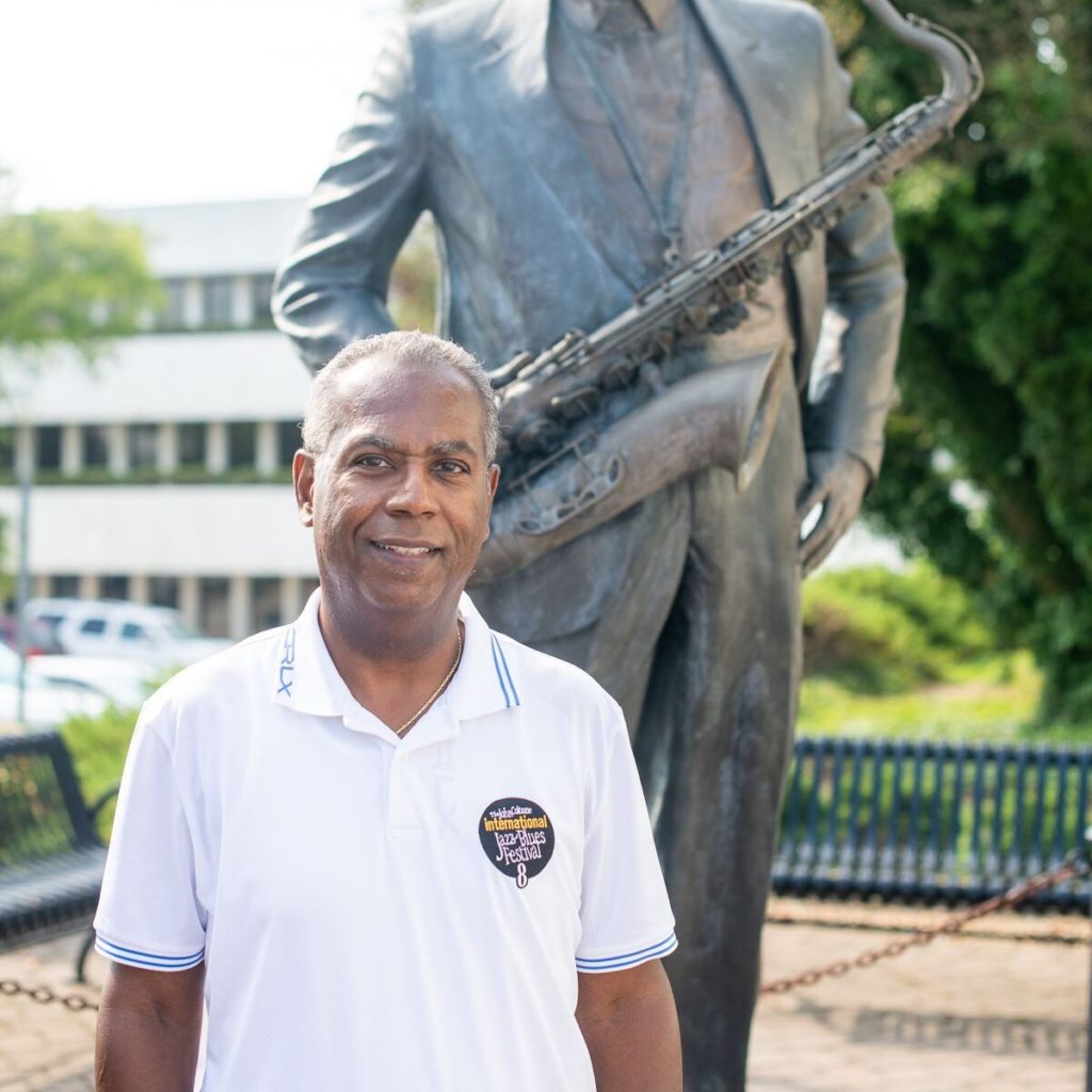 Joe Williams in front of the John Coltrane statue in High Point, NC