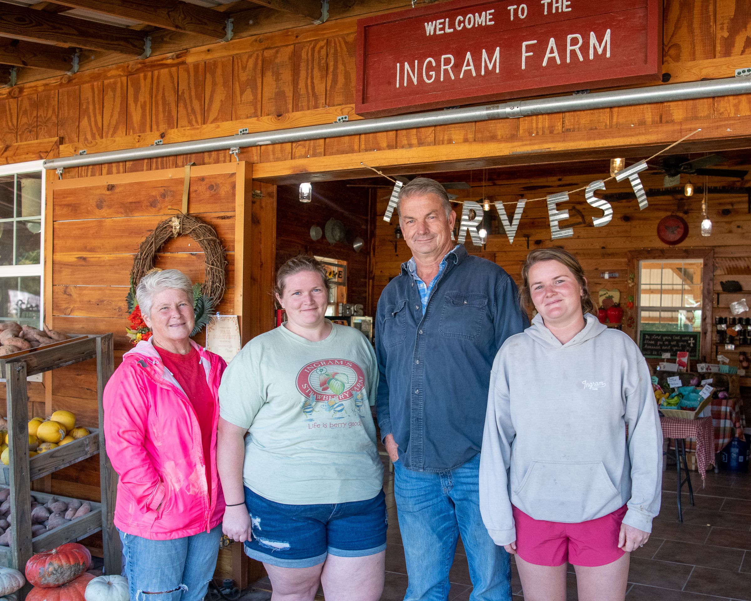 Rhonda Ingram, daughter Casie, Dean Ingram, and daughter Lauren, stand in front of the Ingram's Family Farm store.