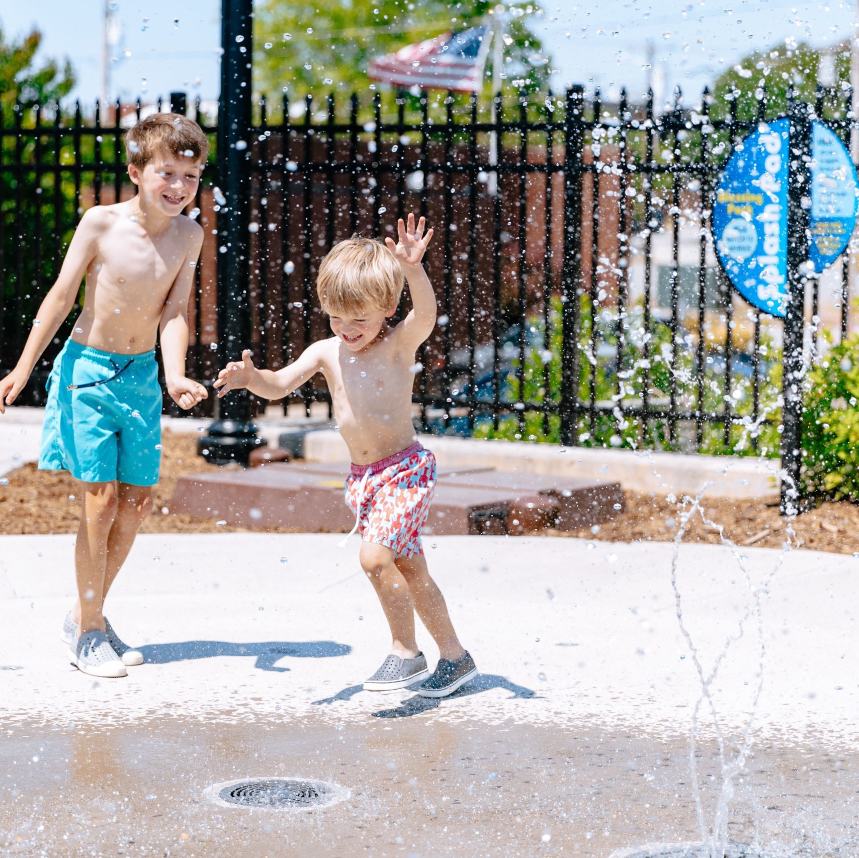 Two children play in a sprinkler at Blessing Park in High Point, NC.