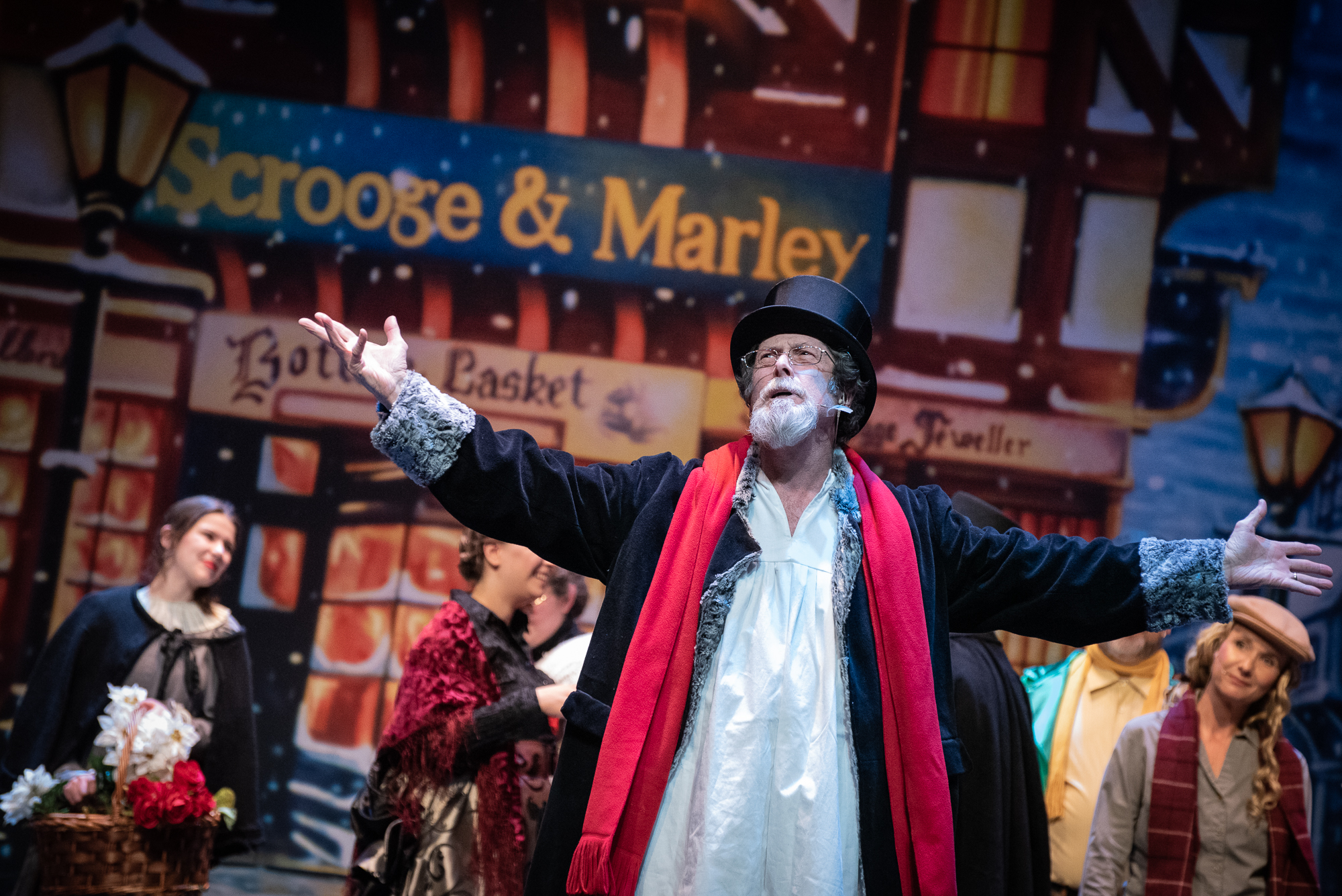 High Point Community Theatre presents A Christmas Carol: The Musical. Scrooge sings on stage at the High Point Theatre.