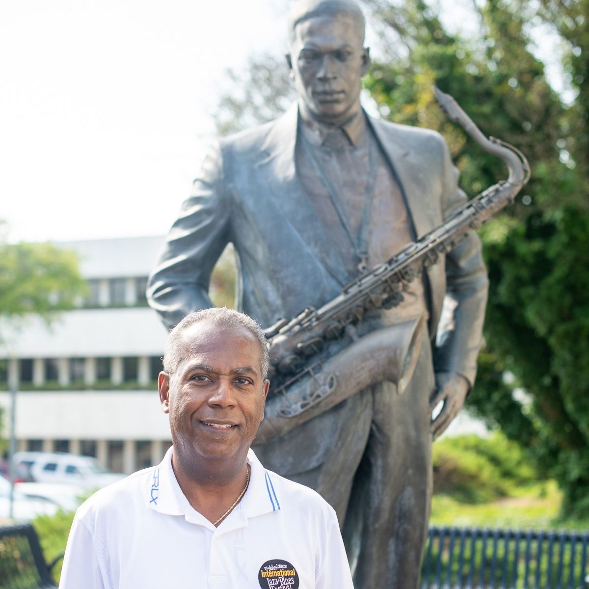 Joe Williams stands in front of a statue of John Coltrane in High Point, NC.
