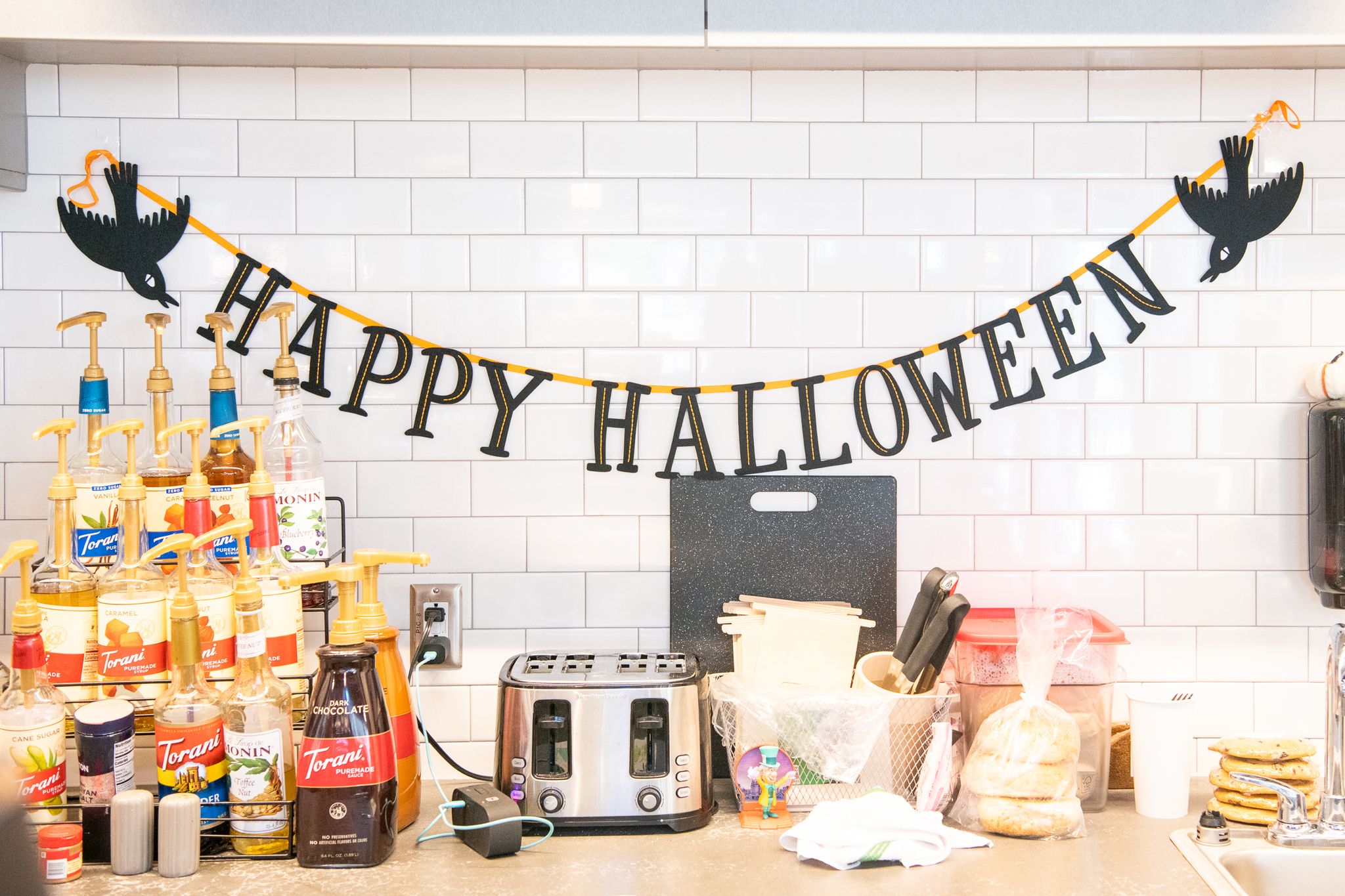 A Happy Halloween banner hangs over the coffee counter at Lil's Coffee Bar.