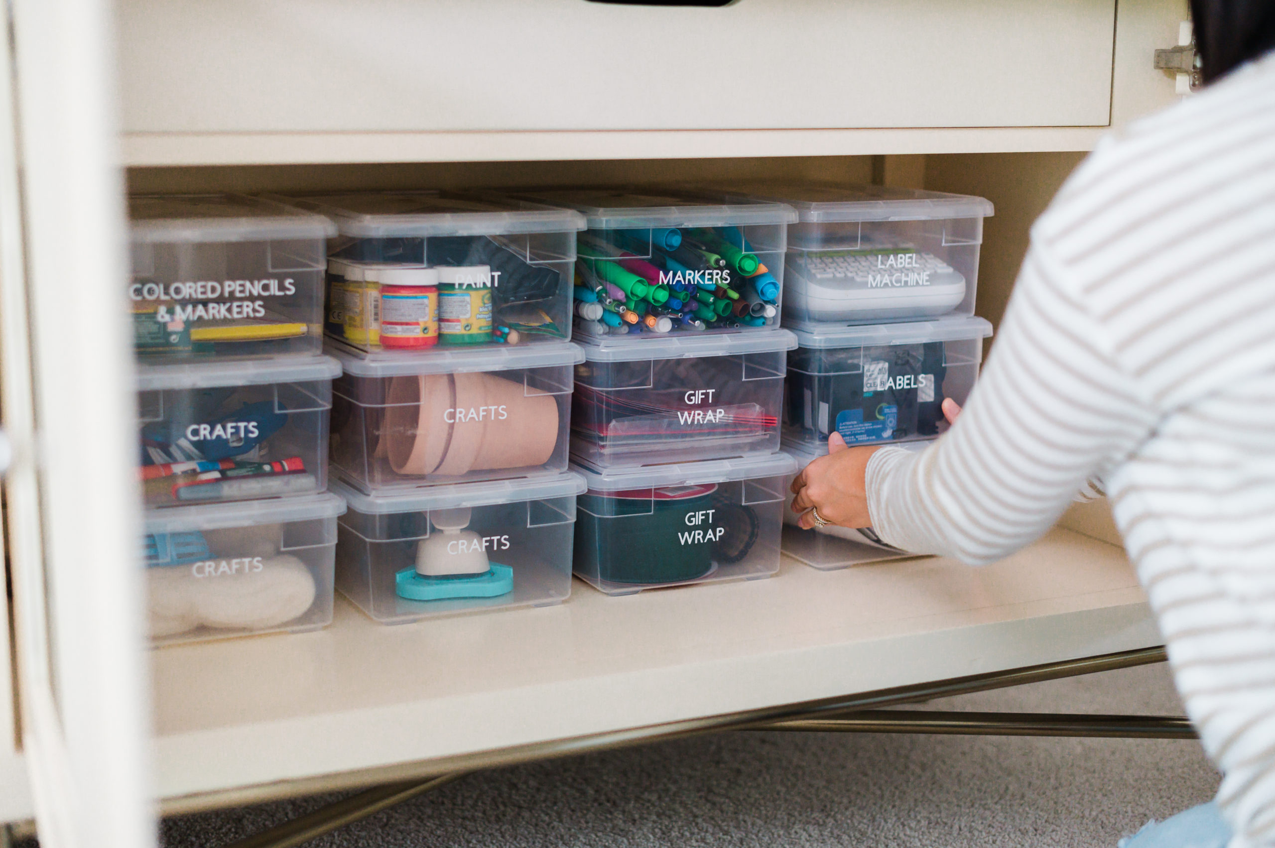 A woman organizes shelves.