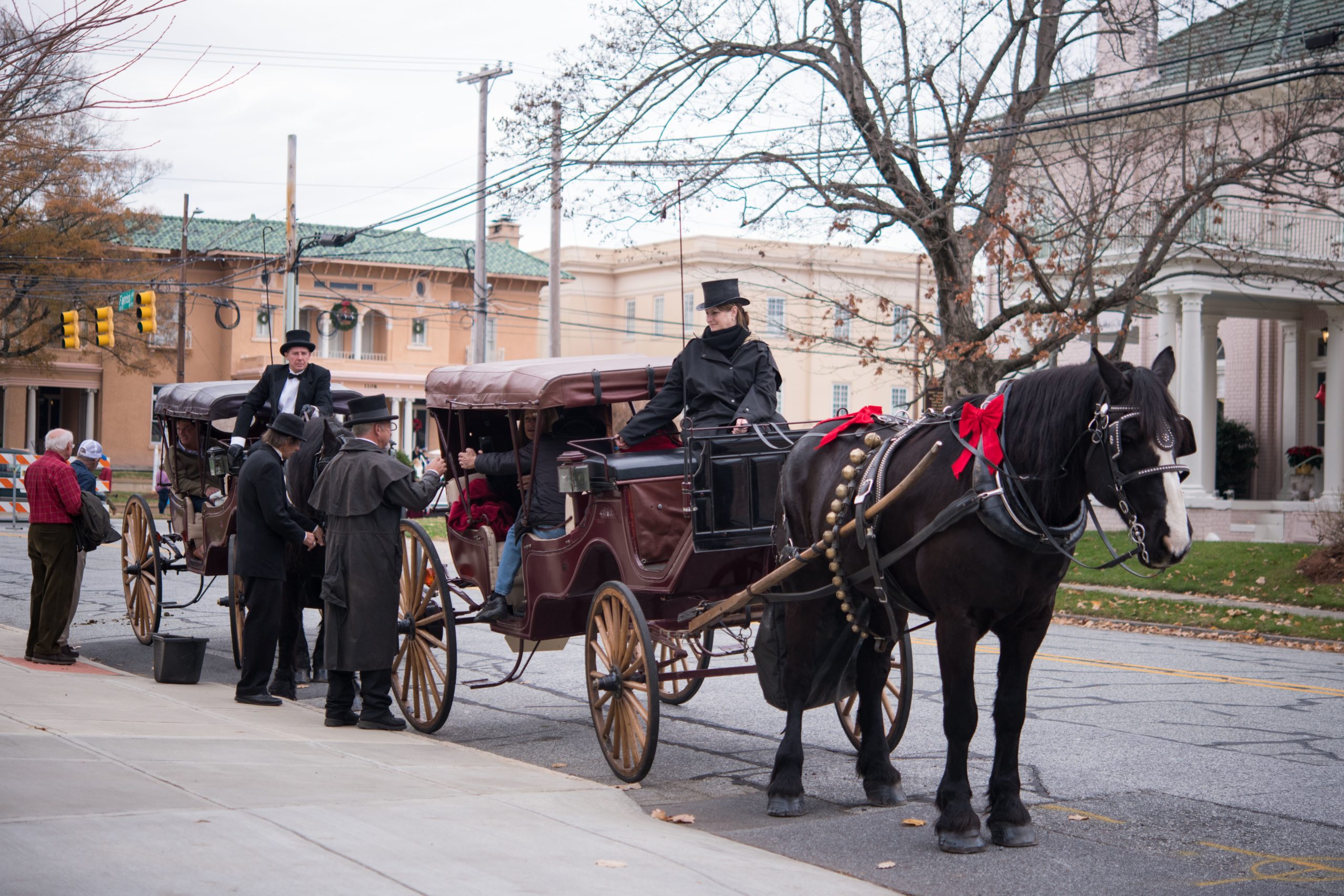 People getting into a horse-drawn carriage in uptowne High Point, NC.