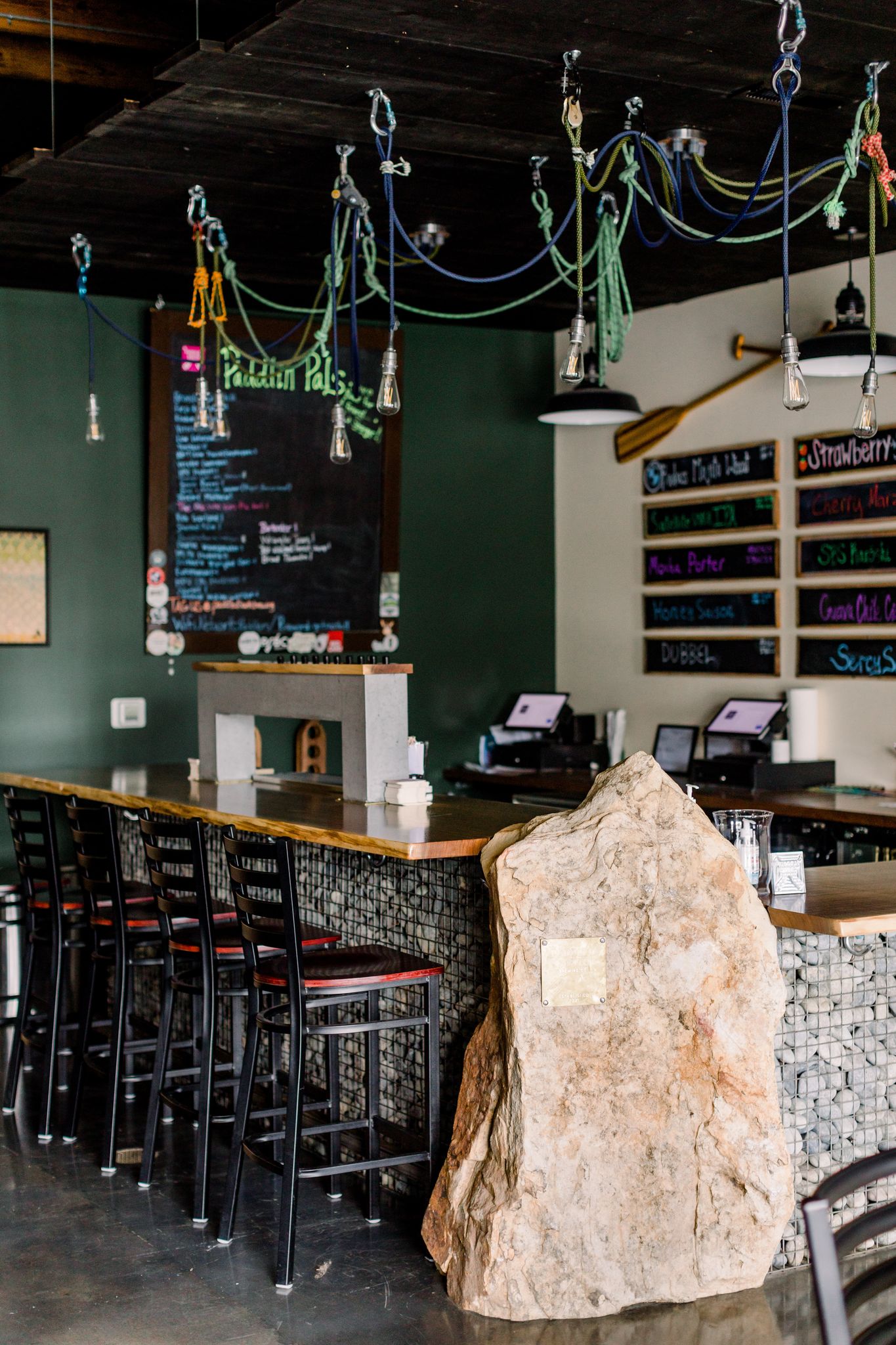 Bar and taps at Paddled South Brewing Co. in High Point, NC, designed with rock wall by Stabb Designs.