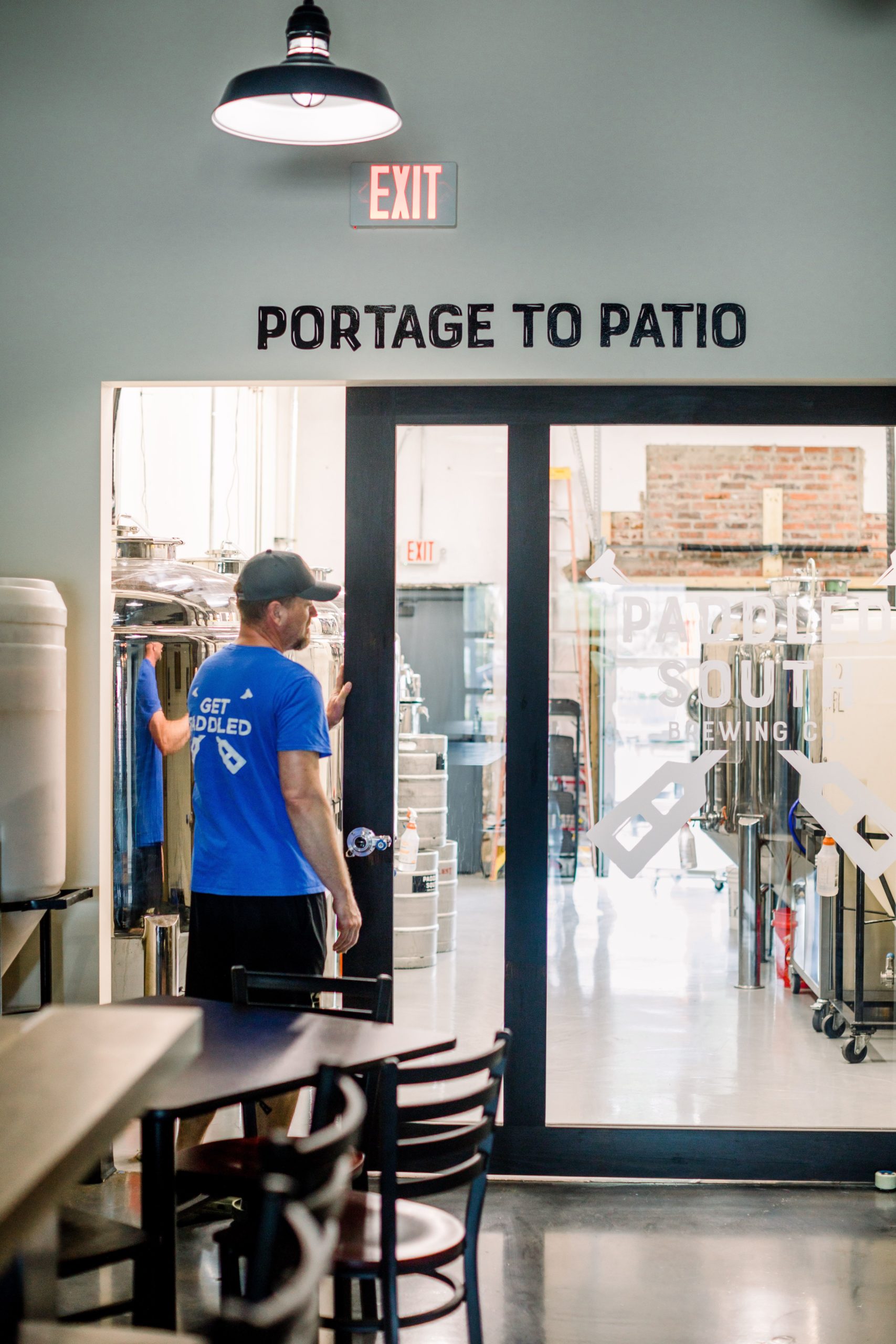 Dave Nissen opens the door for the brewery at Paddled South Brewing Co. in High Point, NC.