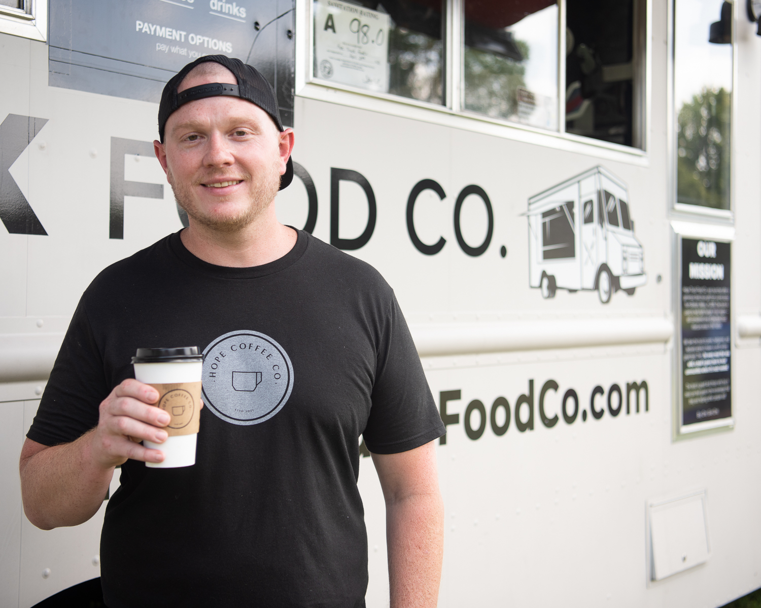 Charles Myers, Manager of Given Coffee, stands in front of the Hope Truck Food Co. truck in High Point, NC.