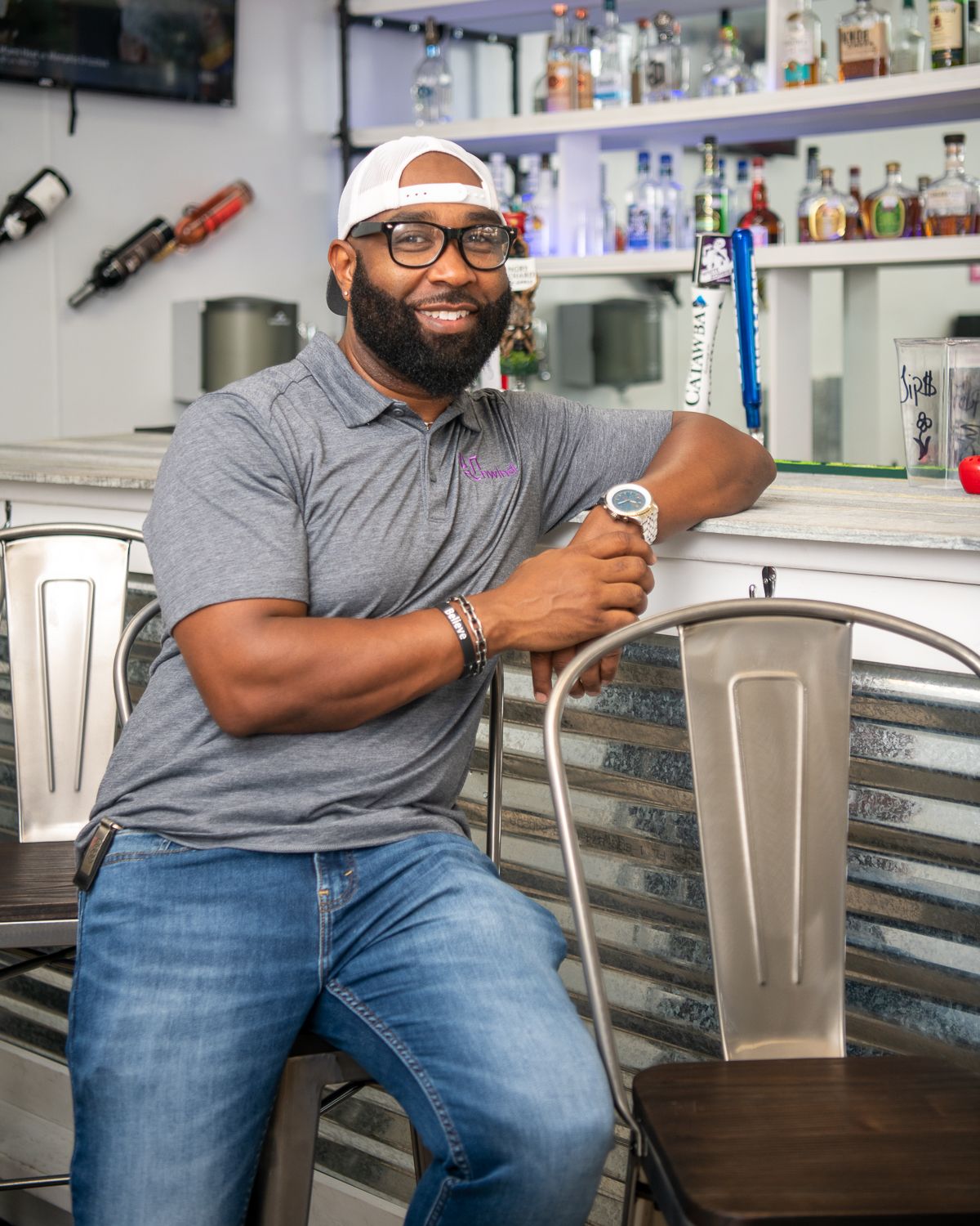 Anthony Anderson sits at the bar counter at Unwind on Main Cafe & Bar in High Point, NC