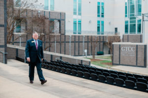 Dr. Mark Harris walks through the amphitheater on the High Point campus of Guilford Technical Community College.