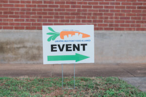 A sign directing people to a Greater High Point Food Alliance event in High Point, NC