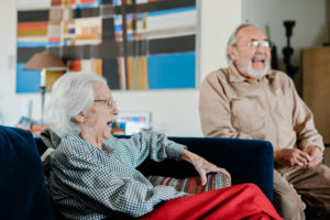 Bert and Shirley Rau laugh on the couch in High Point, NC
