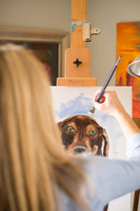 Sarah Lytle, of Sarah Lytle Art in High Point, NC, paints a dog.