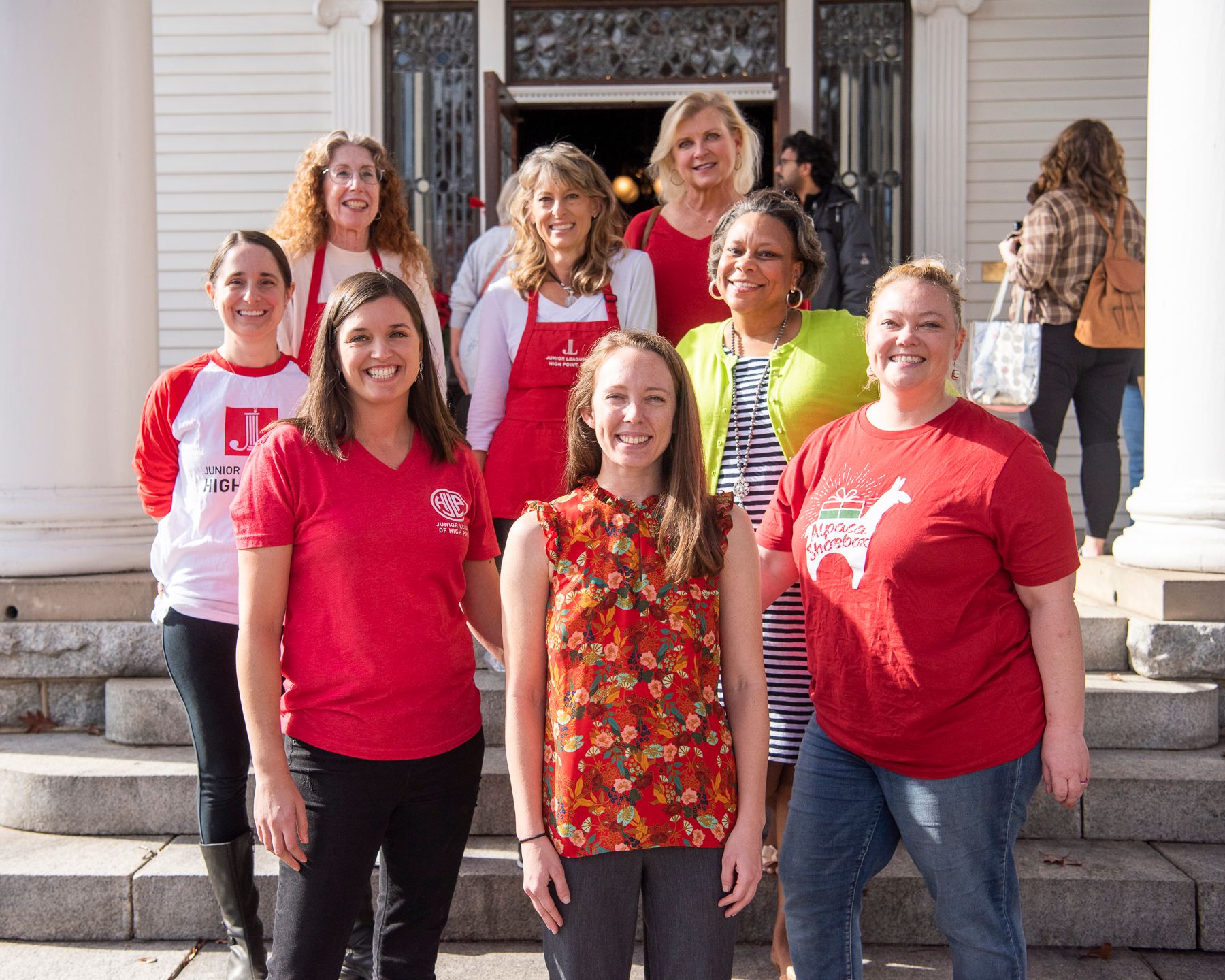 The Junior League of High Point, a group of women devoted to volunteerism in High Point, NC stand on the front steps of their headquarters.