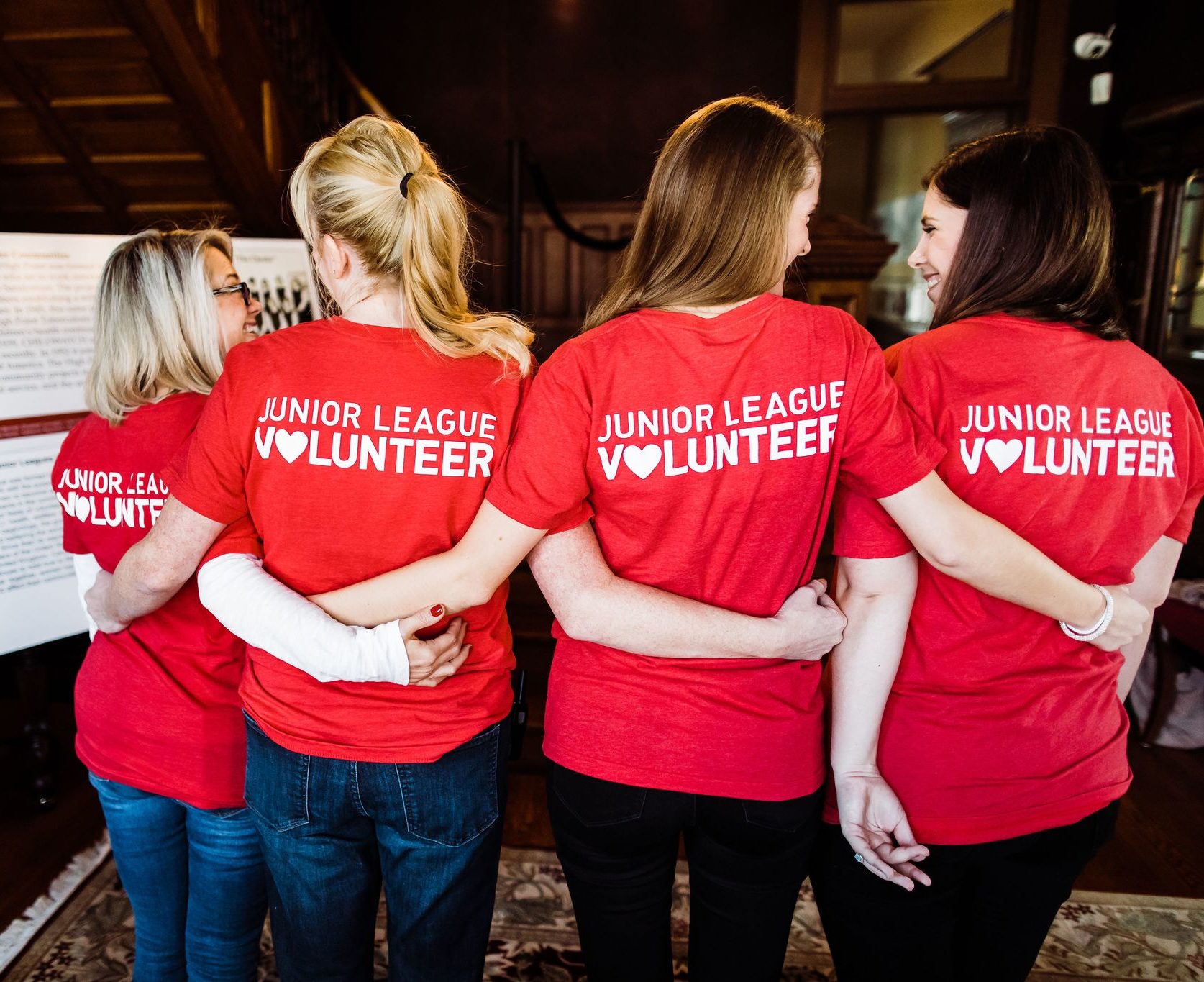 Women wearing Junior League of High Point shirts that read, "Junior League Volunteer."