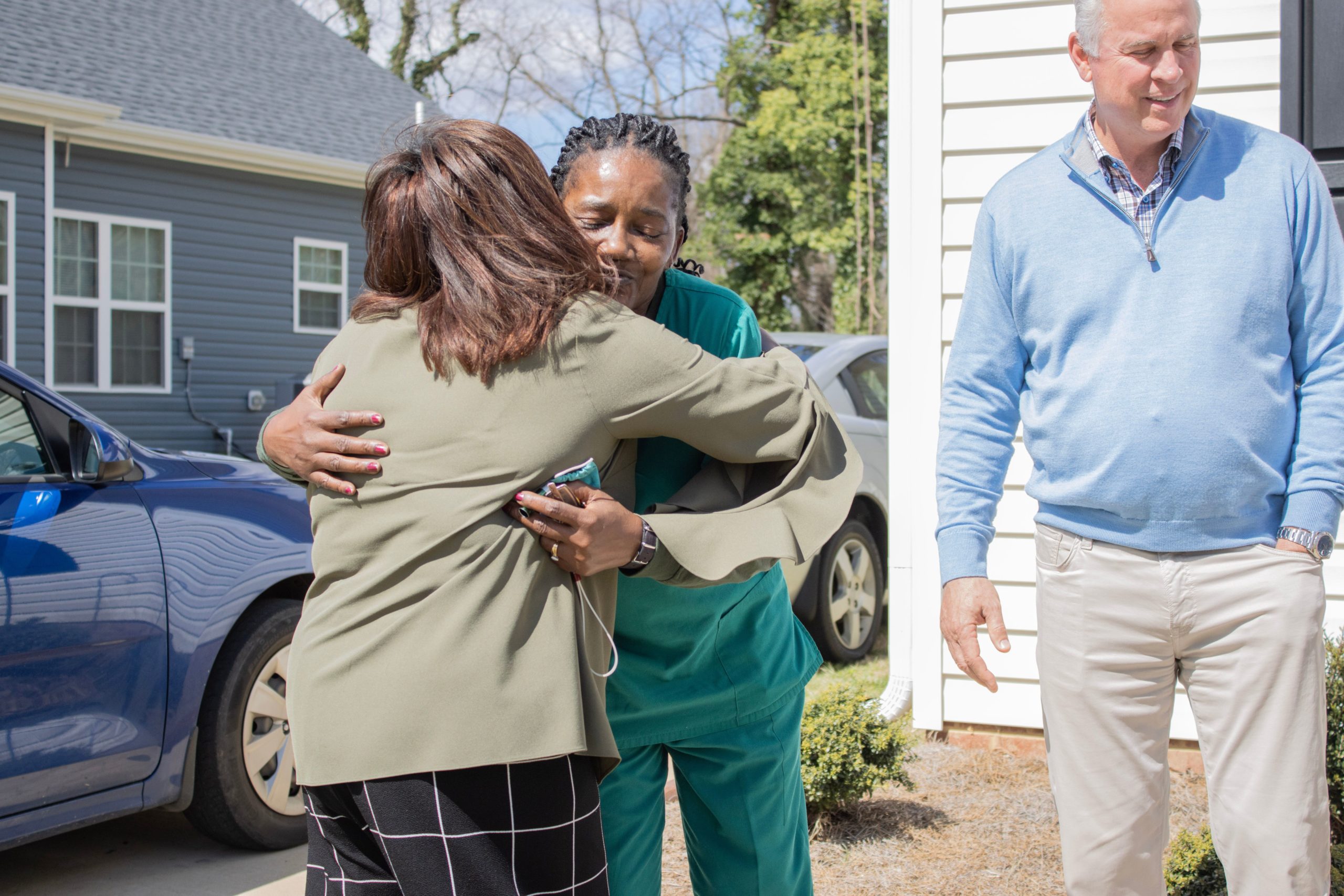 A first-time homeowner, Deborah McBee hugs a woman from Pinnacle Financial Partners as part of the Affordable Housing Program in High Point, NC.
