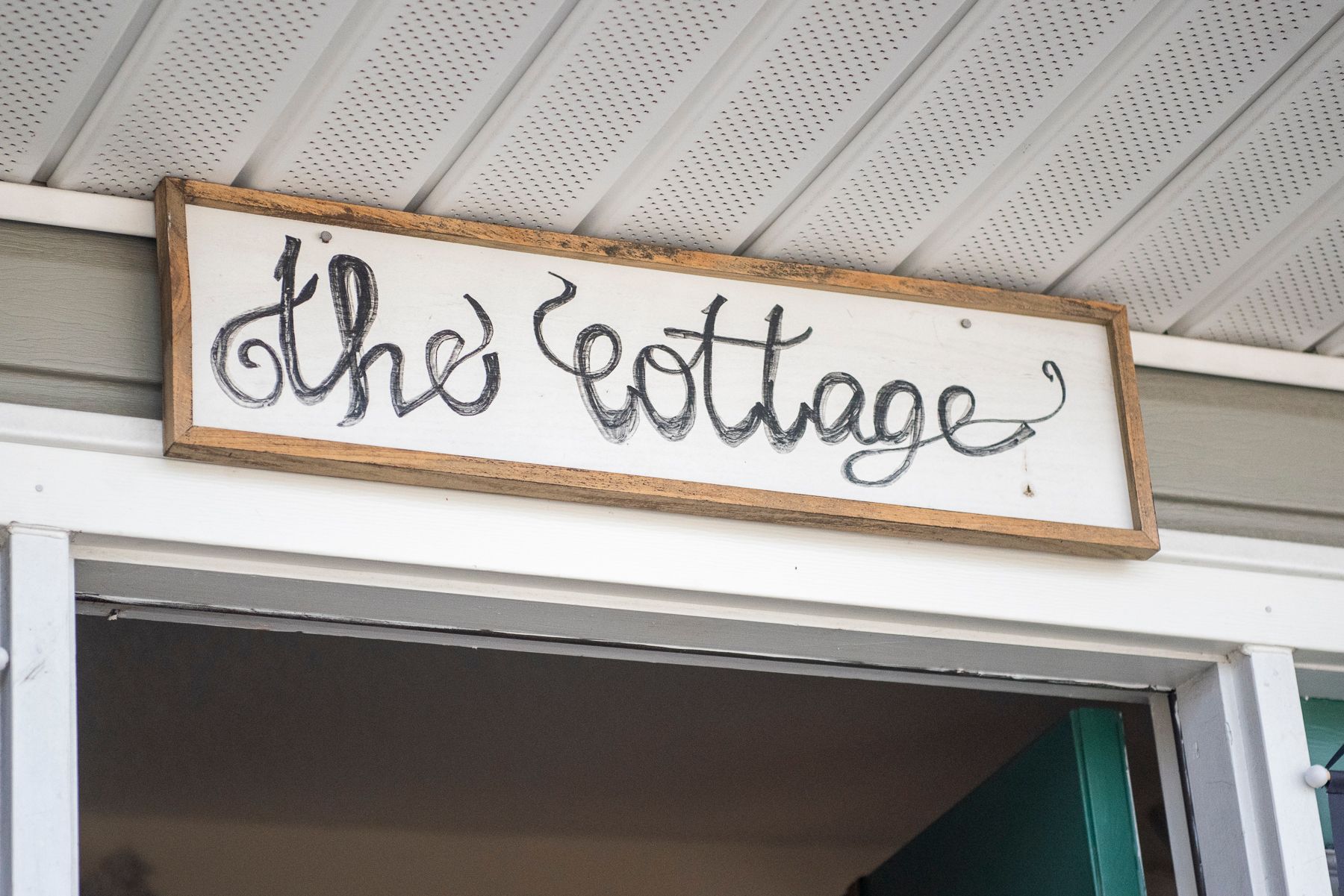 A sign that says "The Cottage" a boutique and gift shop in High Point, NC.