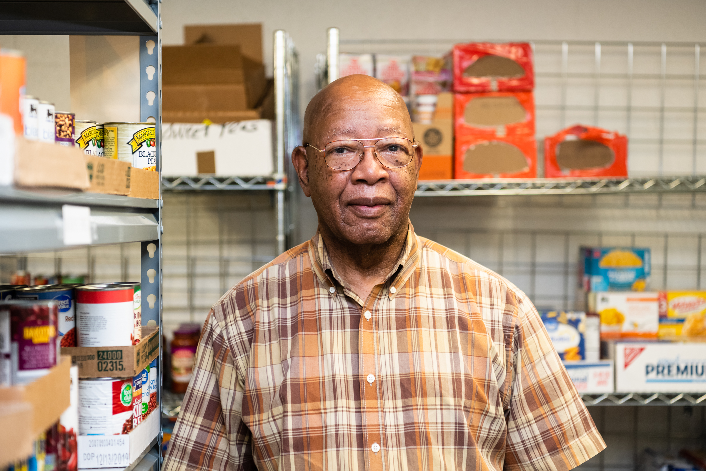 Jerry Mingo, President of the Burns Hill Neighborhood Association stands at the food pantry.