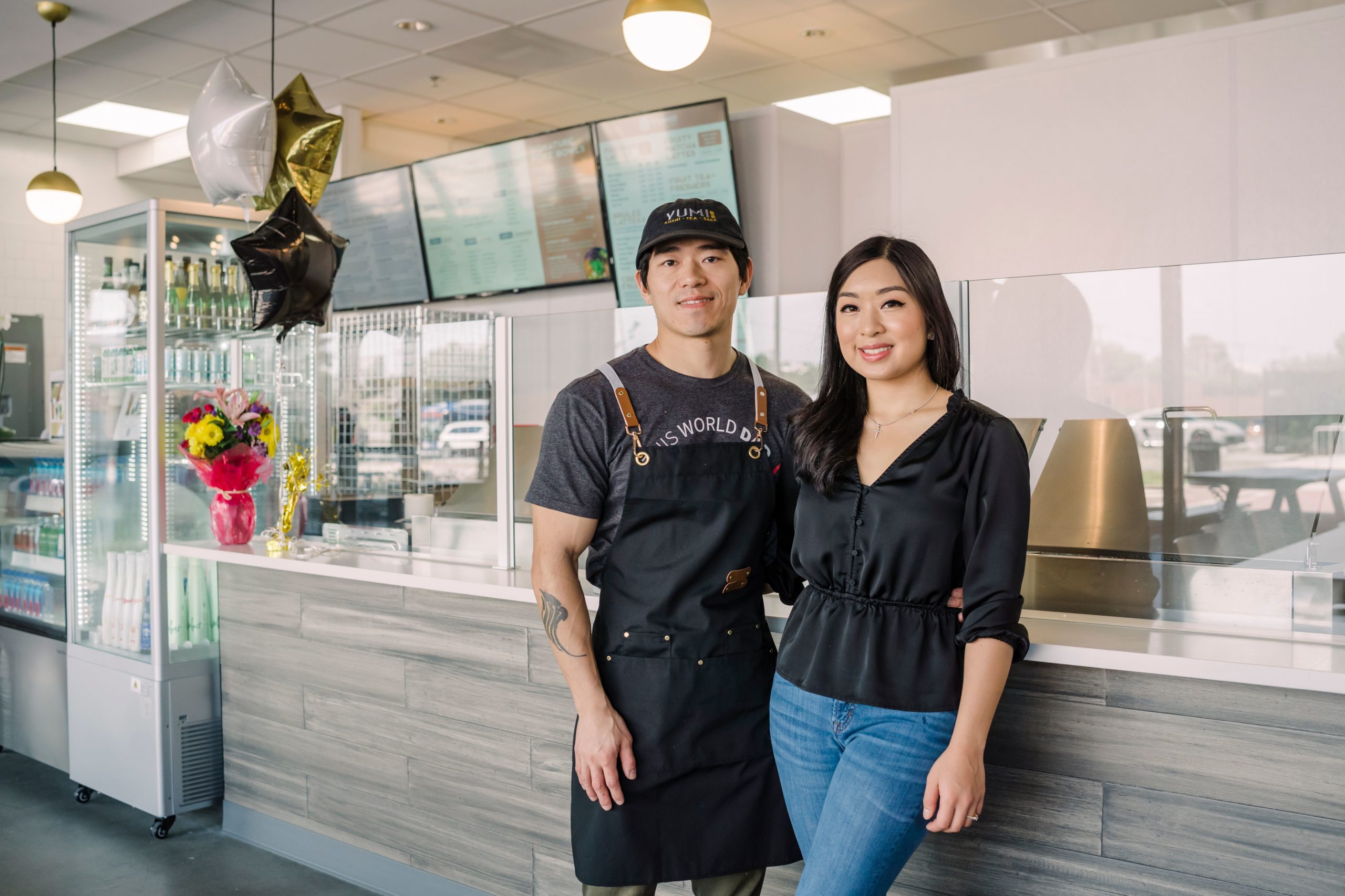 Chen and Jessica, husband and wife owners of Yumi Sushi stand in front of their restaurant at Stock + Grain Assembly.