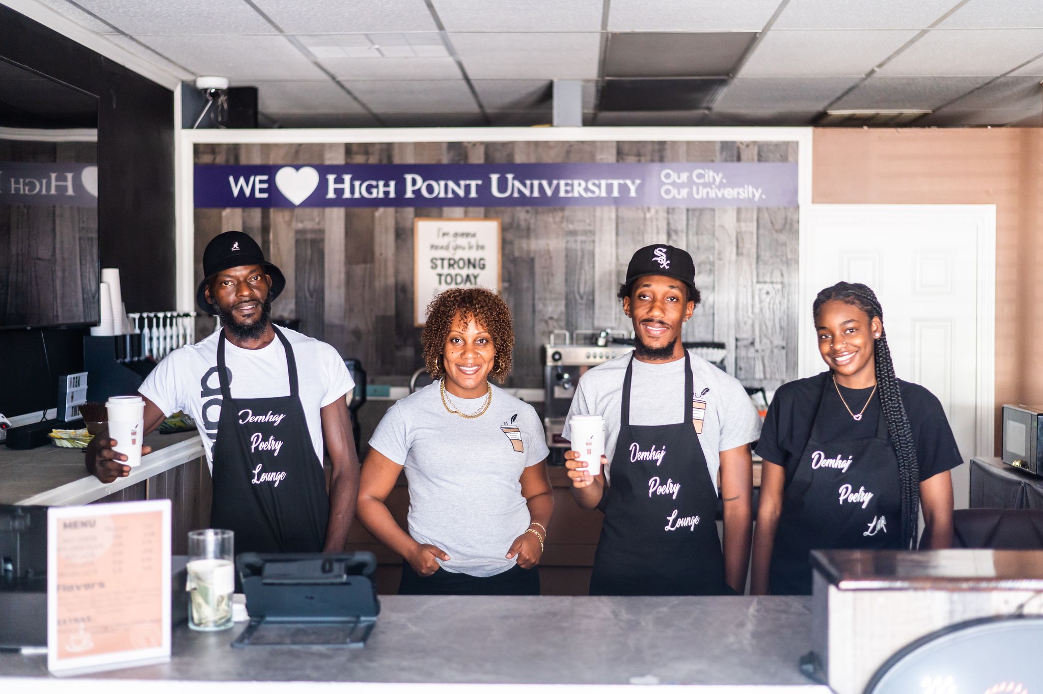 The staff at Demhaj Poetry Lounge stands behind the counter at the High Point coffee shop.